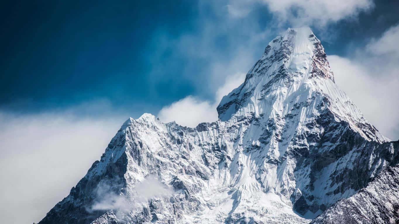 snow-capped mountain peak, swirling clouds, deep blue sky, HD Desktop Wallpaper