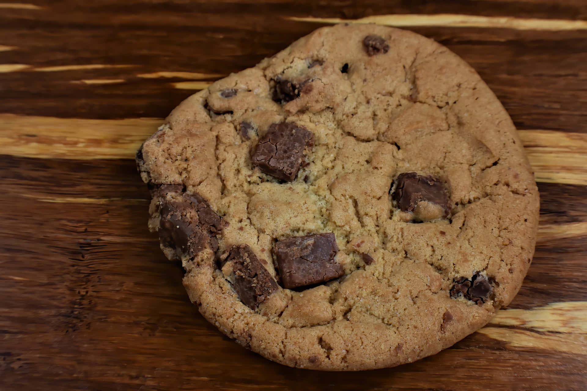 homemade chocolate chip cookie, melted chocolate chunks, rustic wooden surface, Full HD Desktop Wallpaper