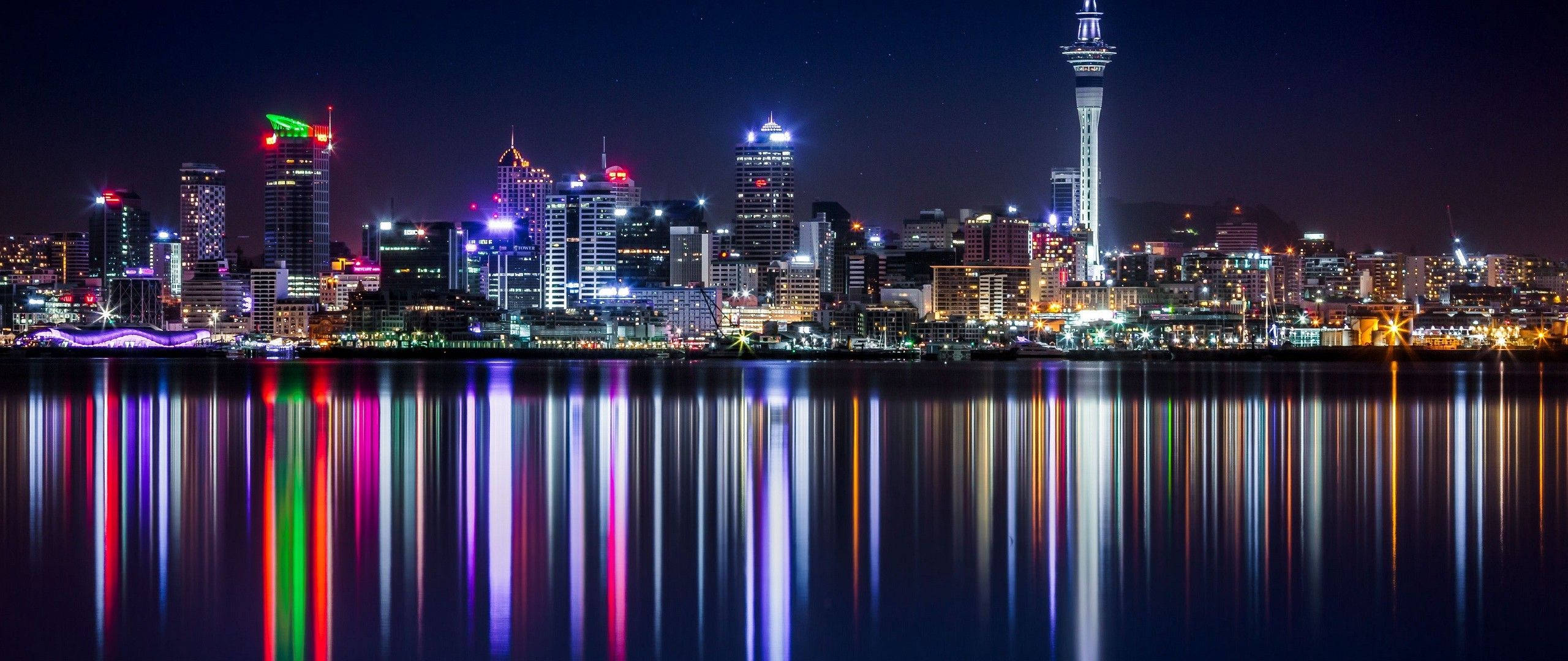 city skyline, neon lights, calm water, 2K Desktop Wallpaper