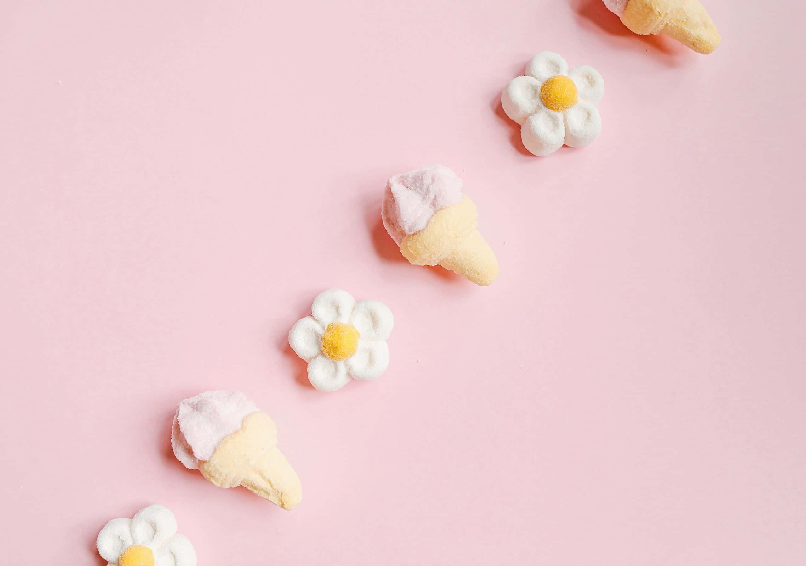 pastel pink background, marshmallow candies shaped like daisies, ice cream cones, 2K Desktop Wallpaper