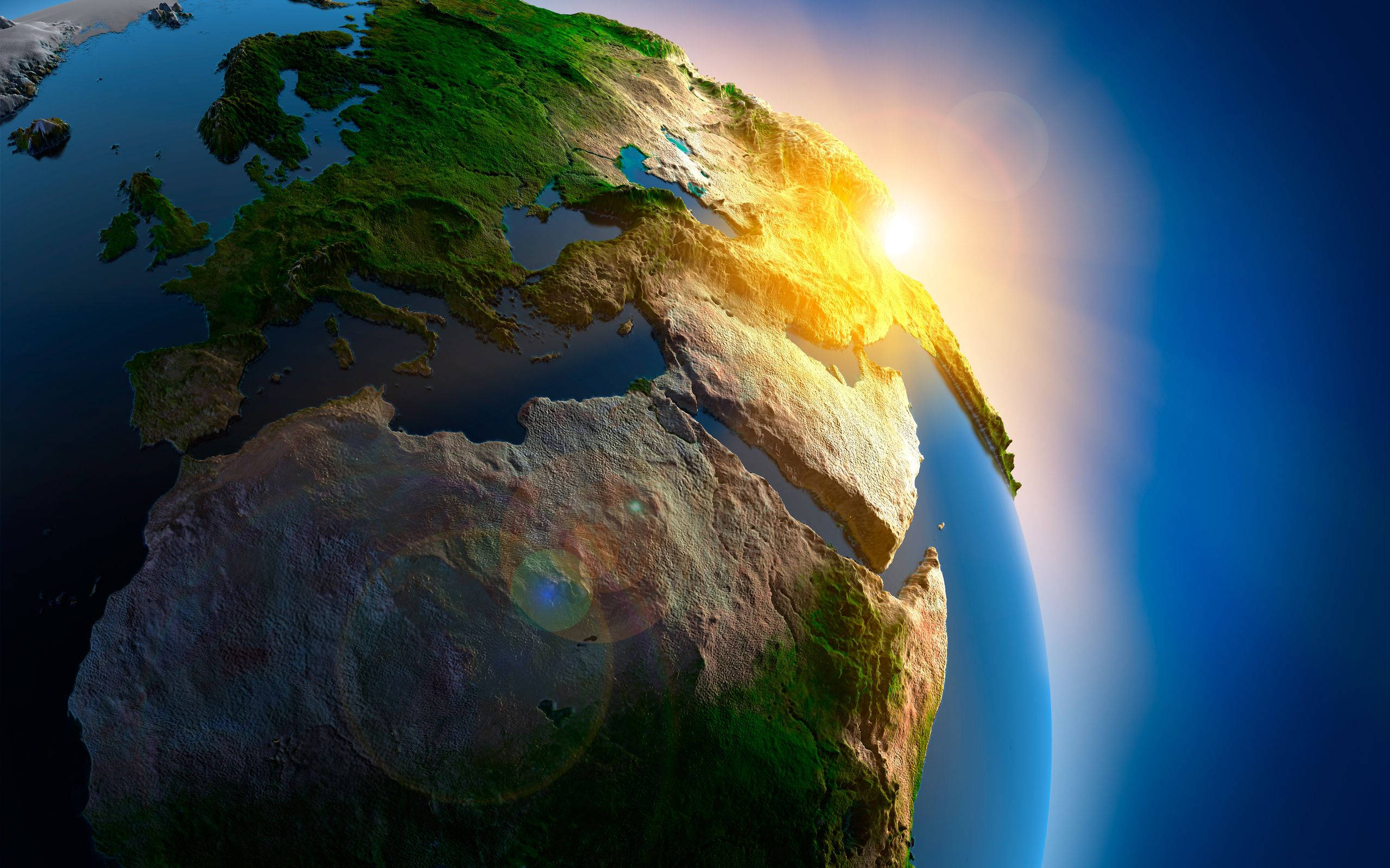 Earth, sun rising over Europe and Africa, golden light across continents and oceans, 2K Desktop Wallpaper