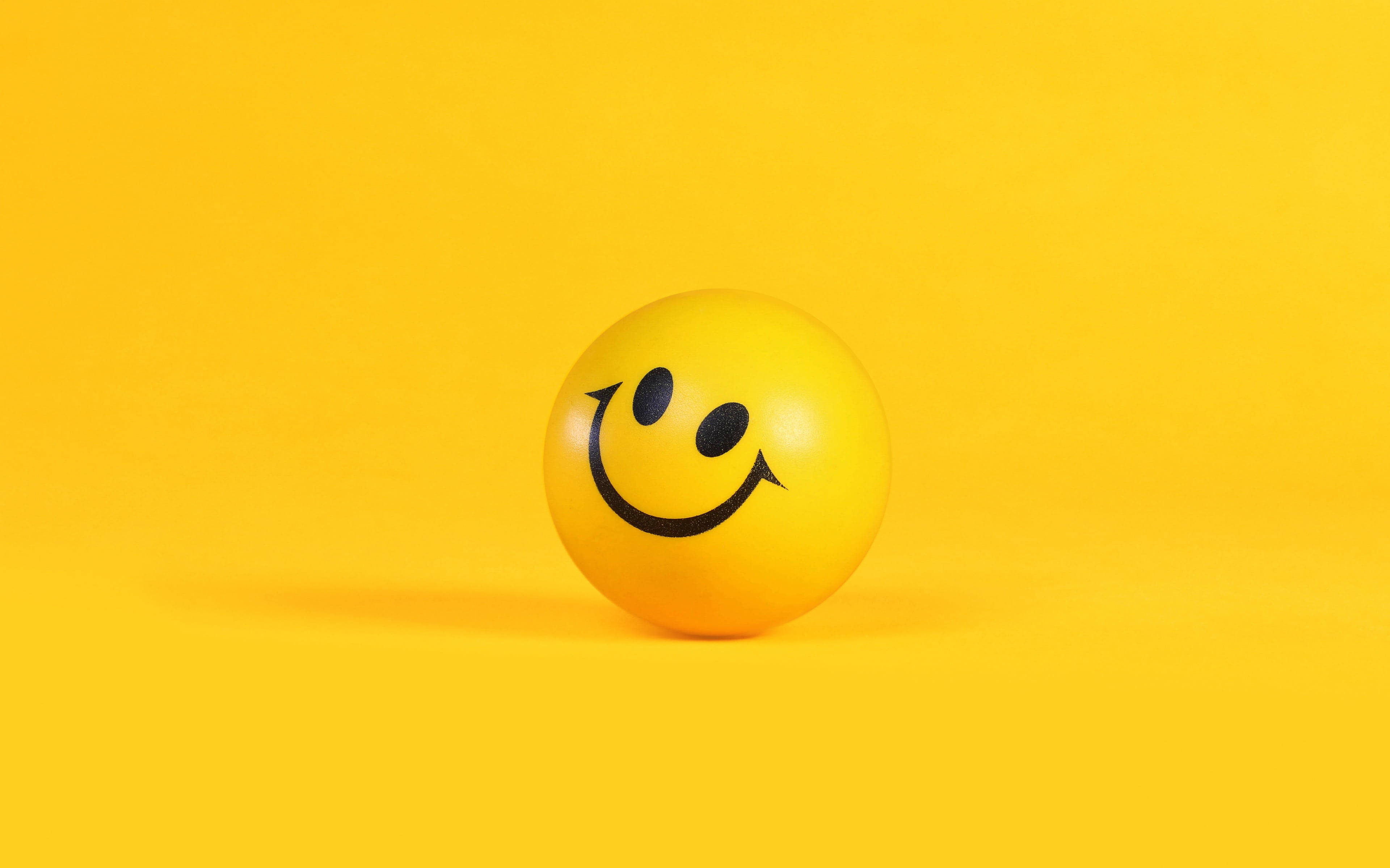 yellow smiley ball, solid yellow background, soft shadow, 4K Desktop Wallpaper