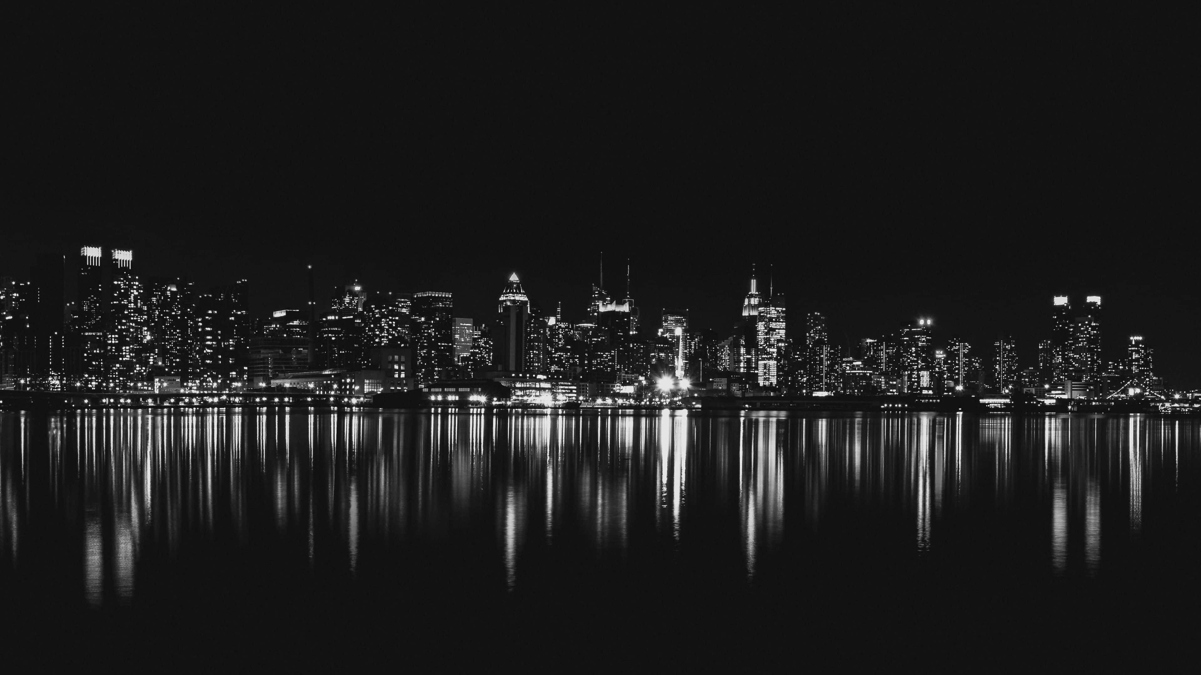monochrome cityscape, night, glowing windows, 4K Desktop Wallpaper