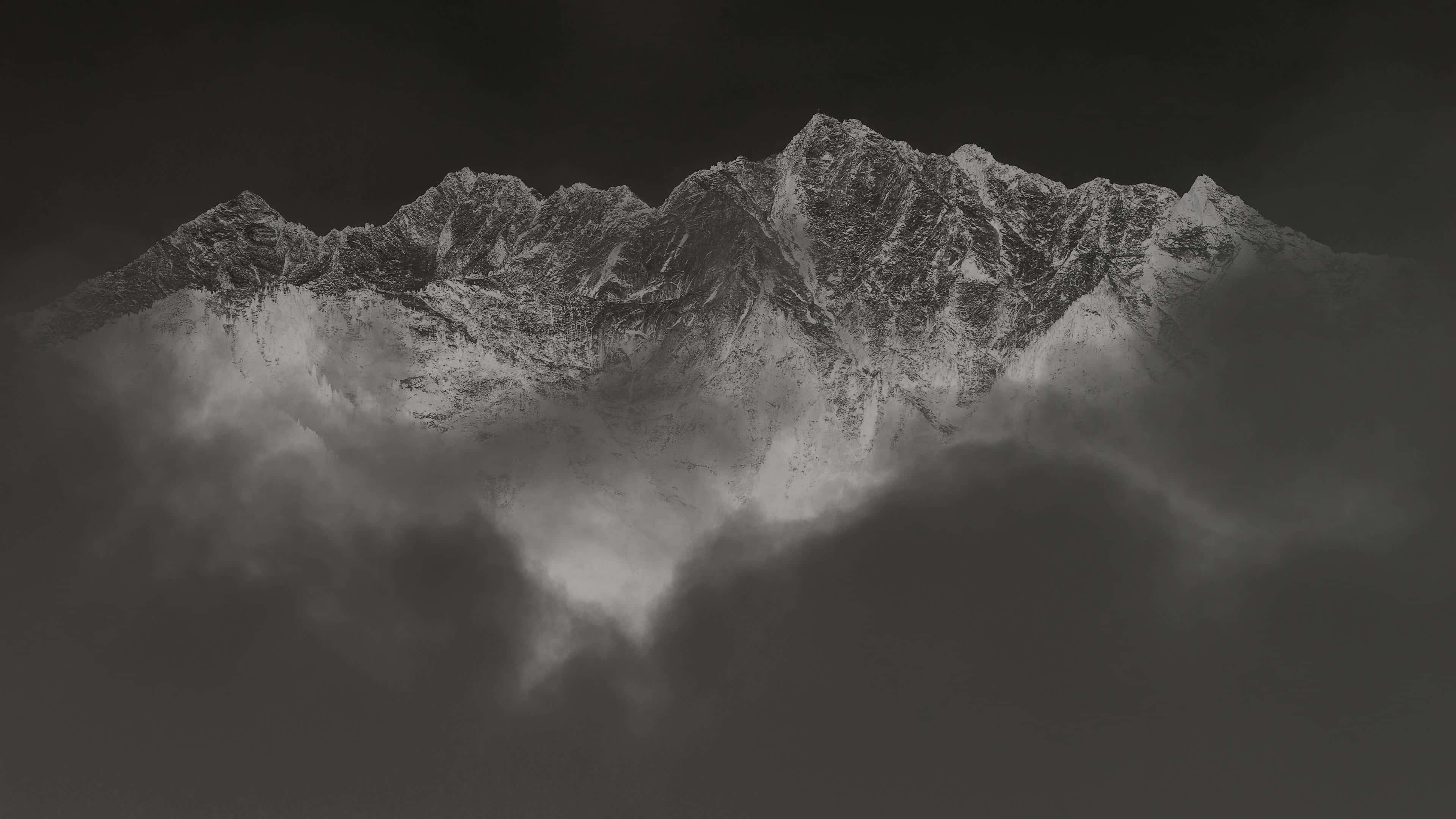 majestic mountain peaks, snowcapped peaks, dense swirling clouds, 4K Desktop Wallpaper