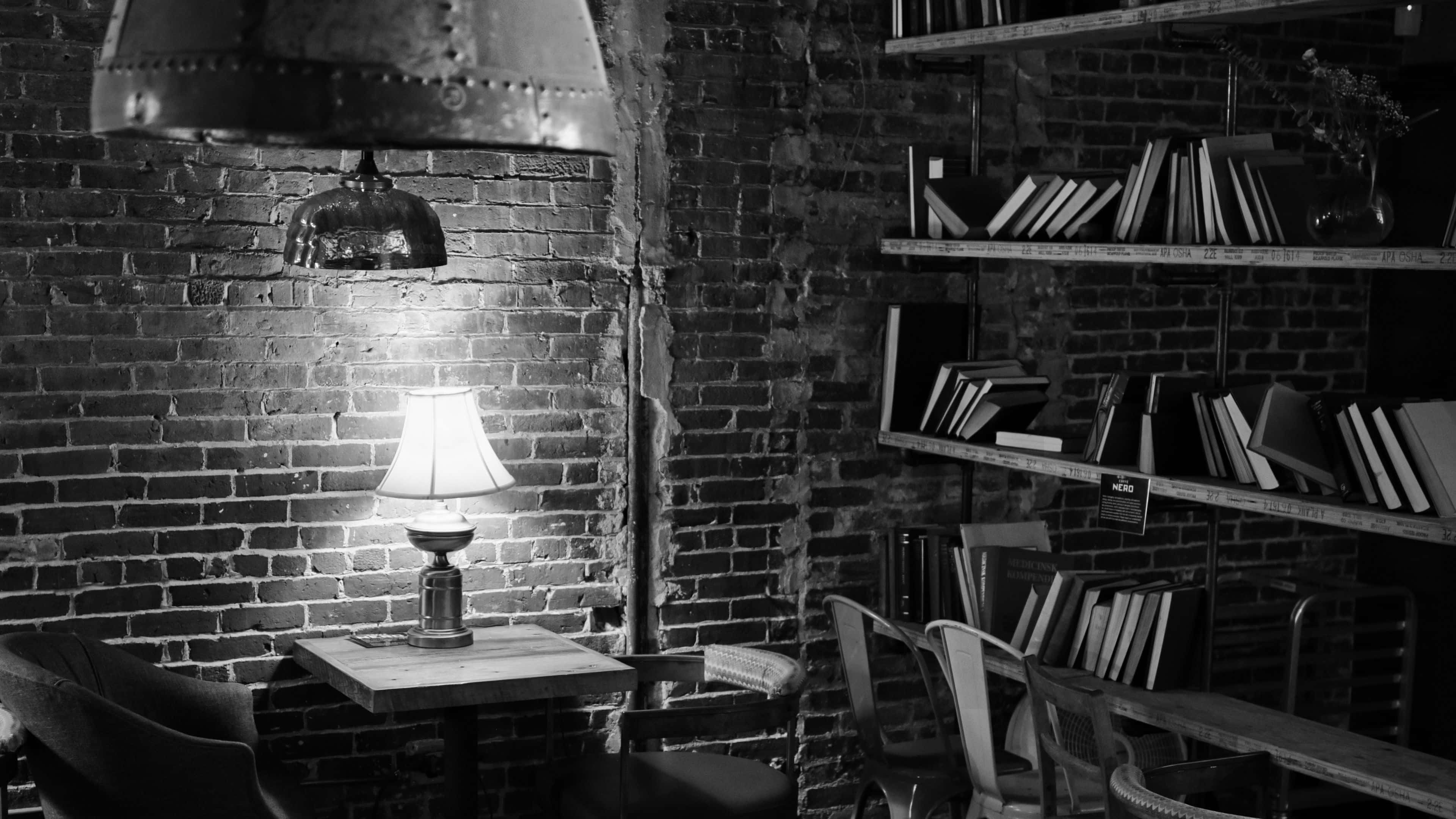 cozy brick wall reading nook, 4K B W, wooden table, 4K Desktop Wallpaper