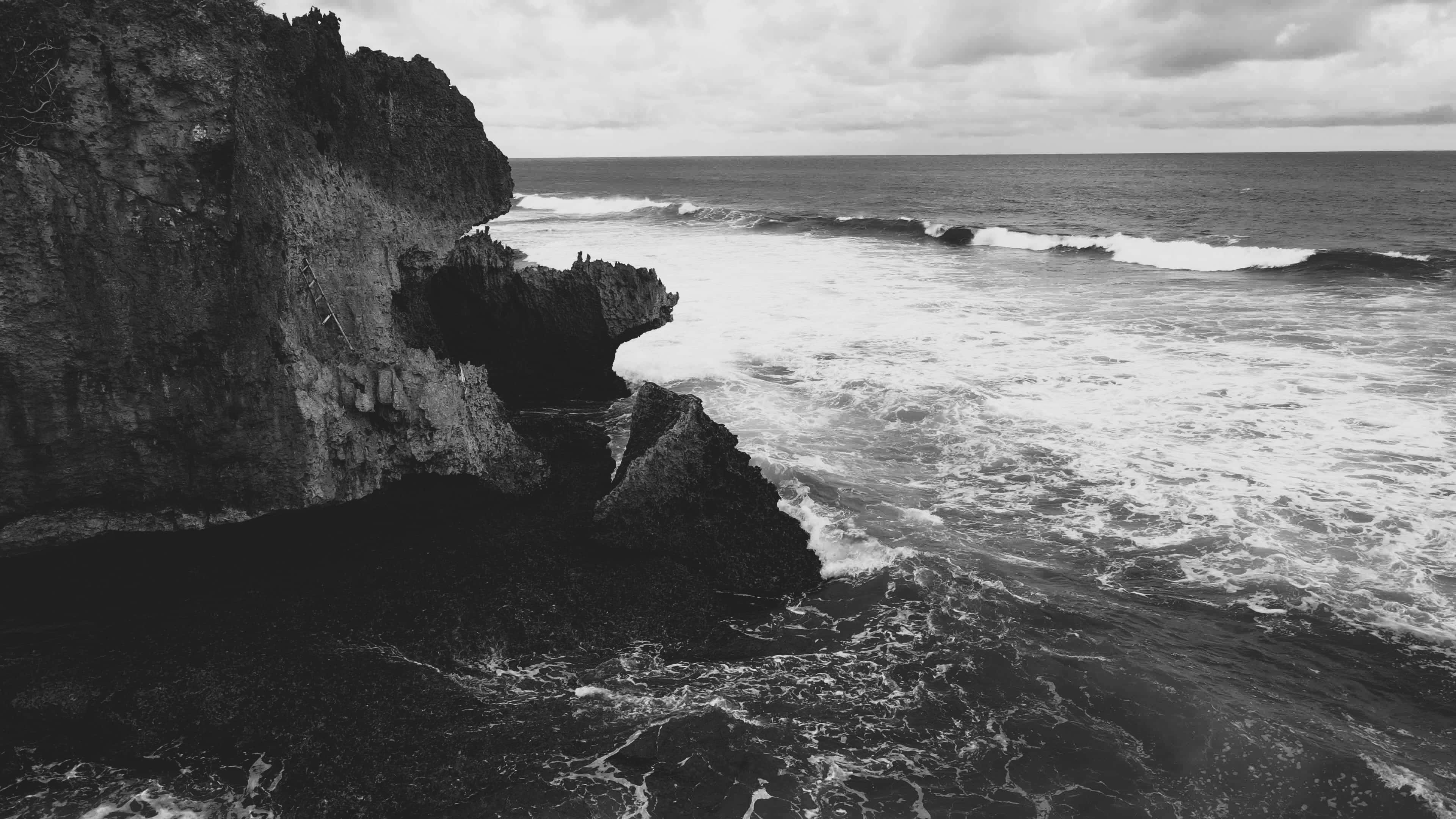 rugged cliffside ocean view, monochrome waves, jagged cliffs, 4K Desktop Wallpaper