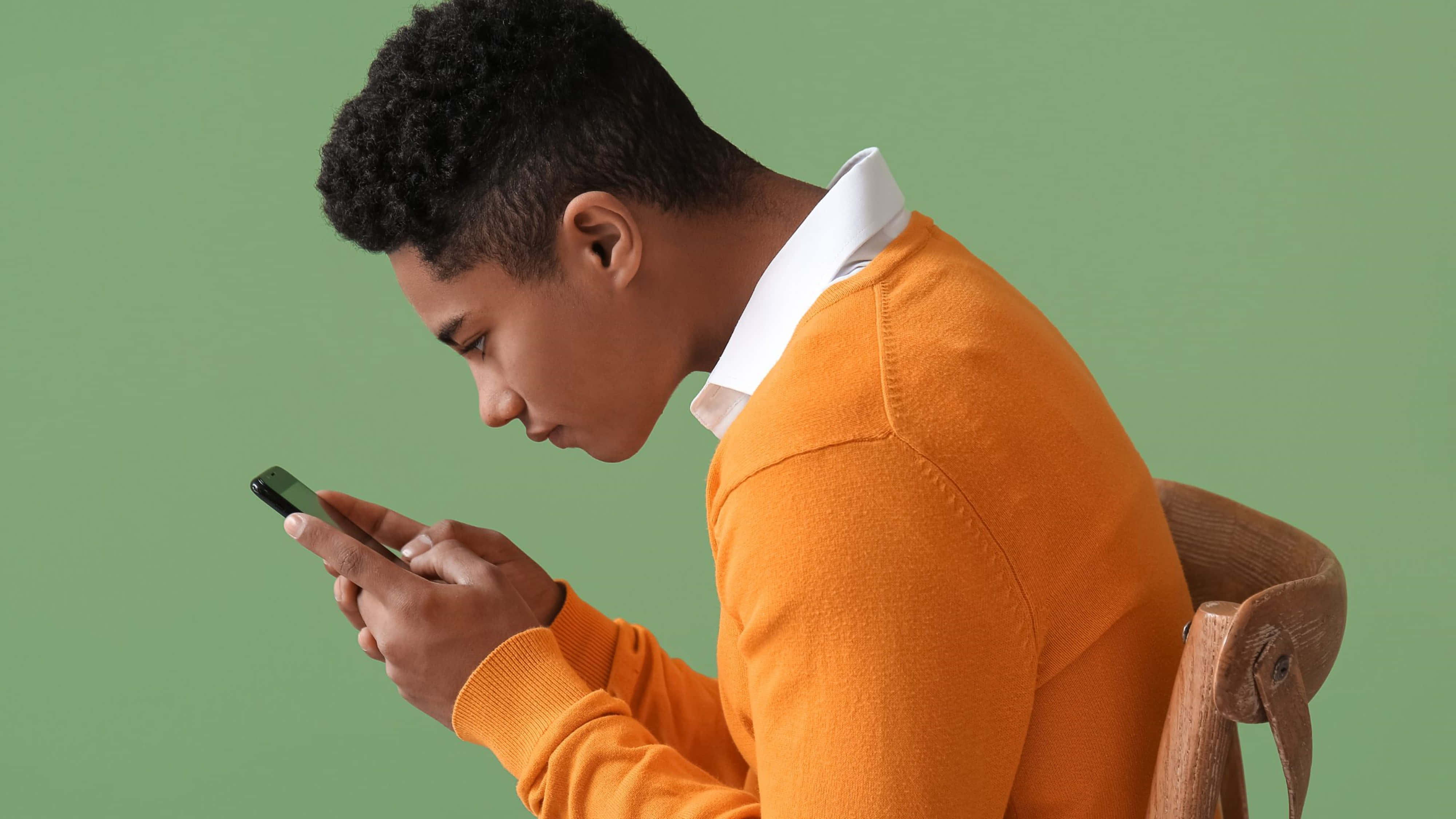 orange sweater, wooden chair, solid green background, 4K Desktop Wallpaper