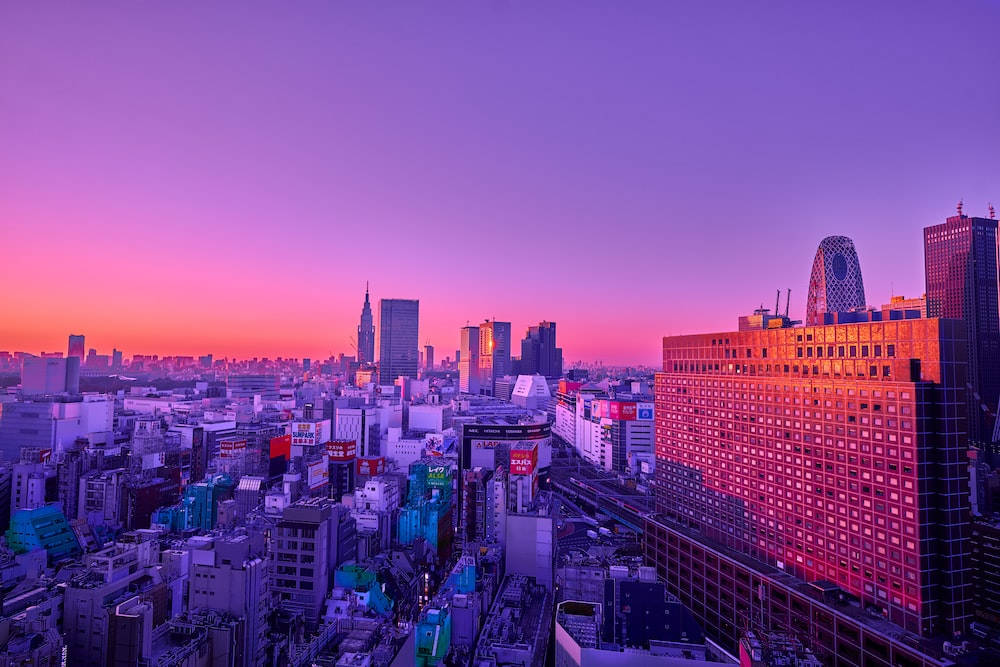 vibrant purple and pink sunset, dense urban skyline, city lights, SD Desktop Wallpaper