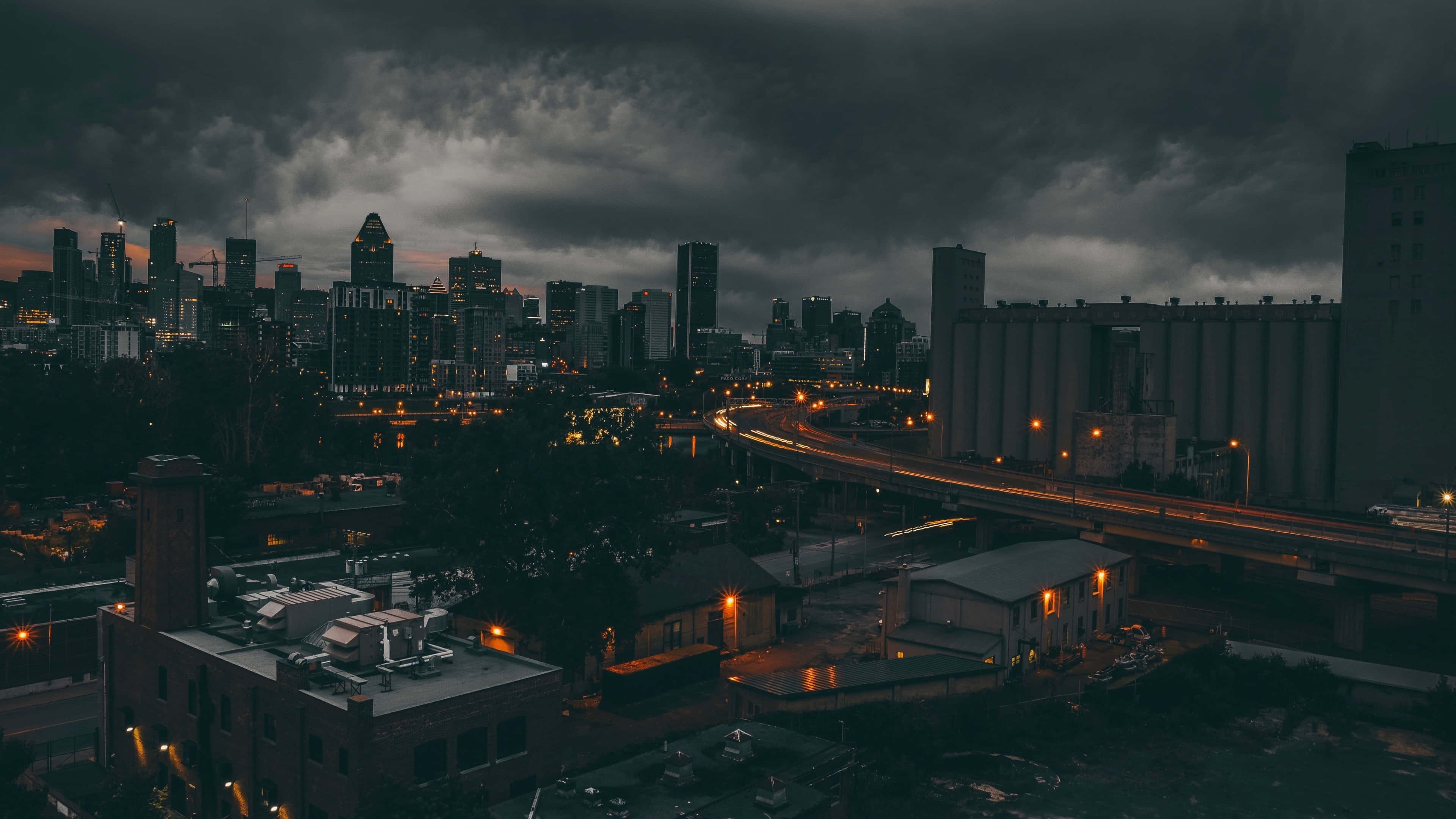 dusk, dark clouds, glowing city lights, 4K Desktop Wallpaper