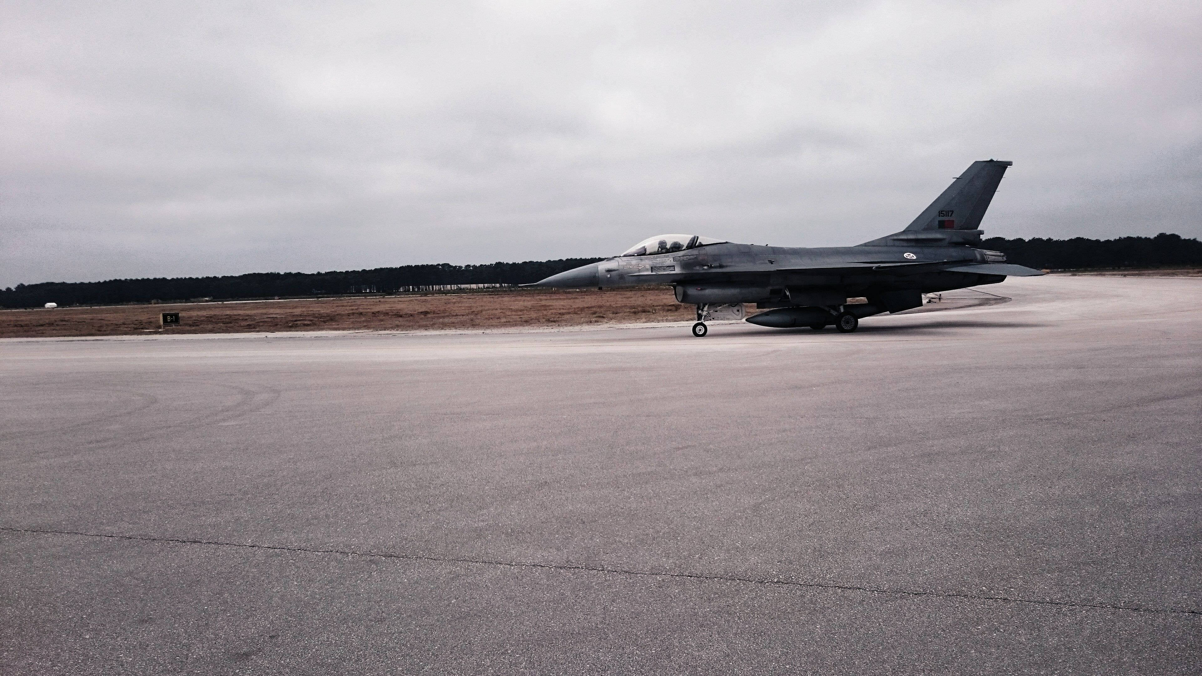 sleek gray fighter jet, wet tarmac, overcast sky, 4K Desktop Wallpaper