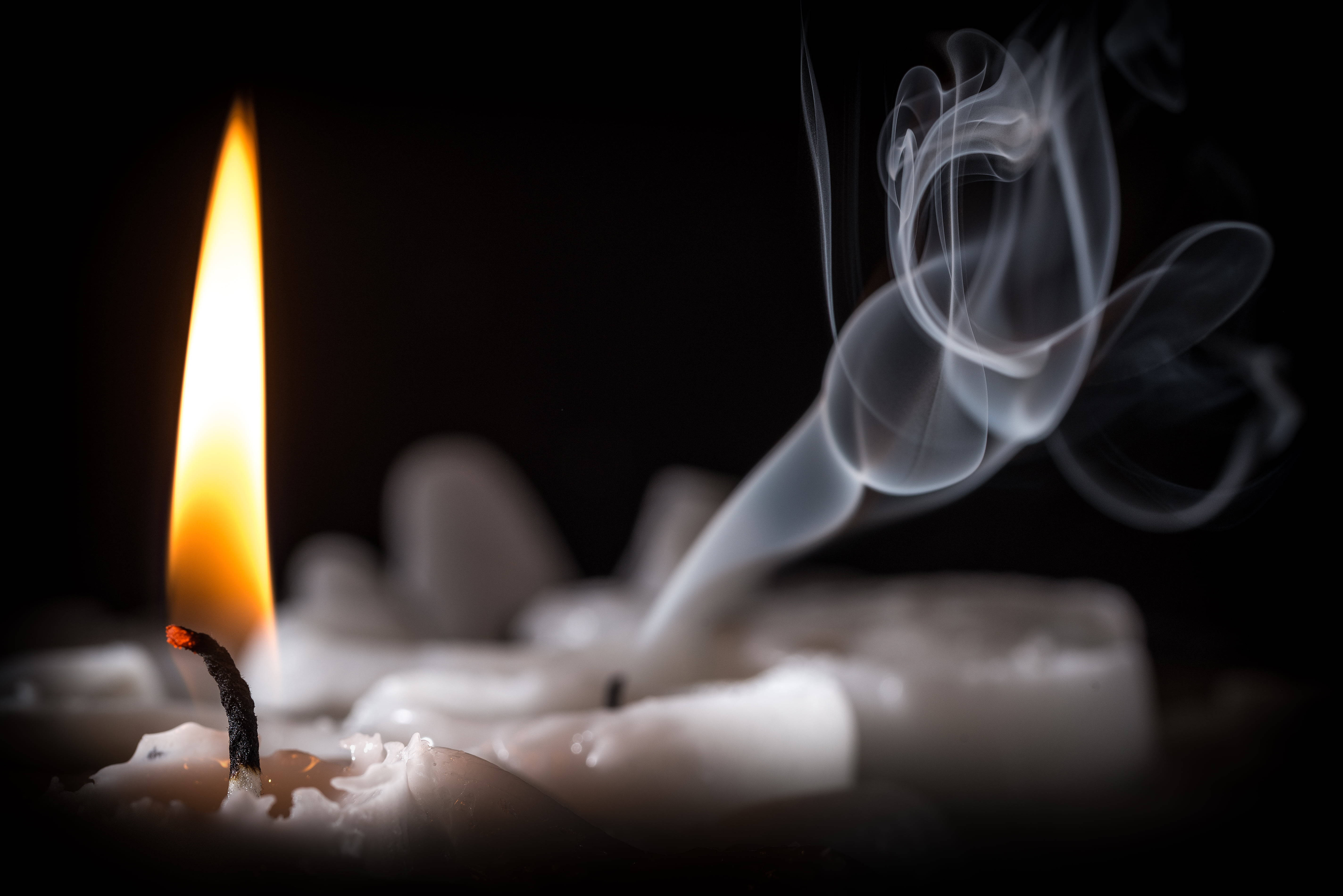 lit candle, warm glow, black background, 5K Desktop Wallpaper