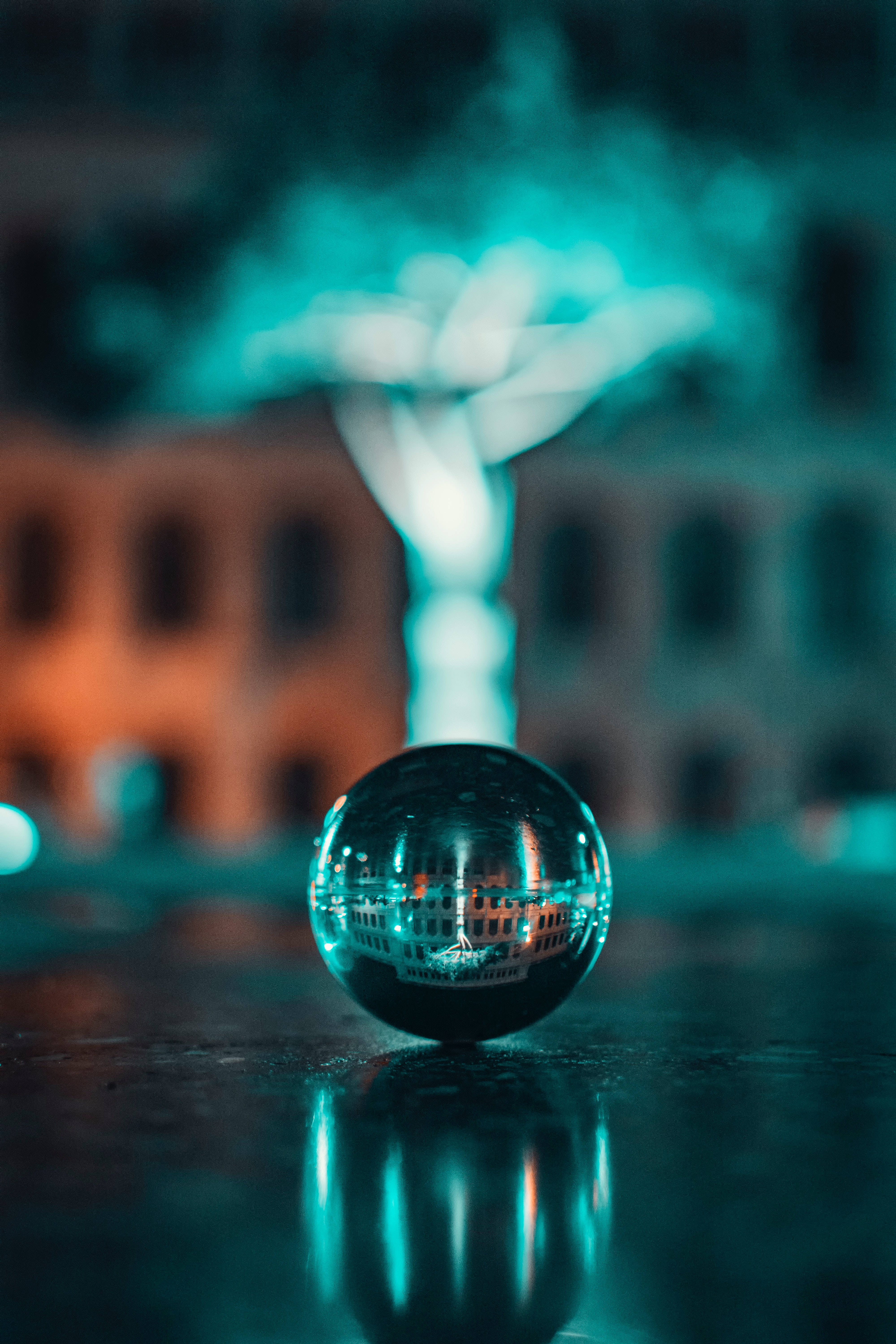 reflective steel ball, glass sphere, cityscape at night, 5K Phone Wallpaper