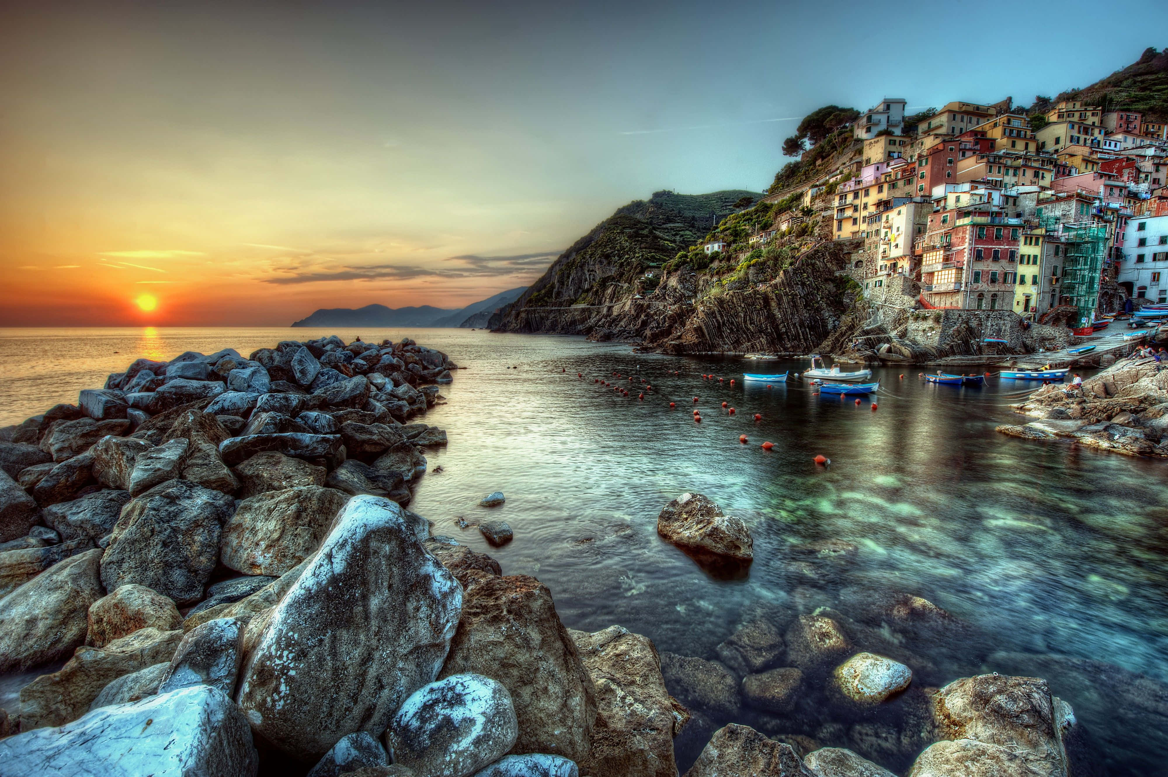 Sunset, calm water, colorful cliffside houses, 4K Desktop Wallpaper