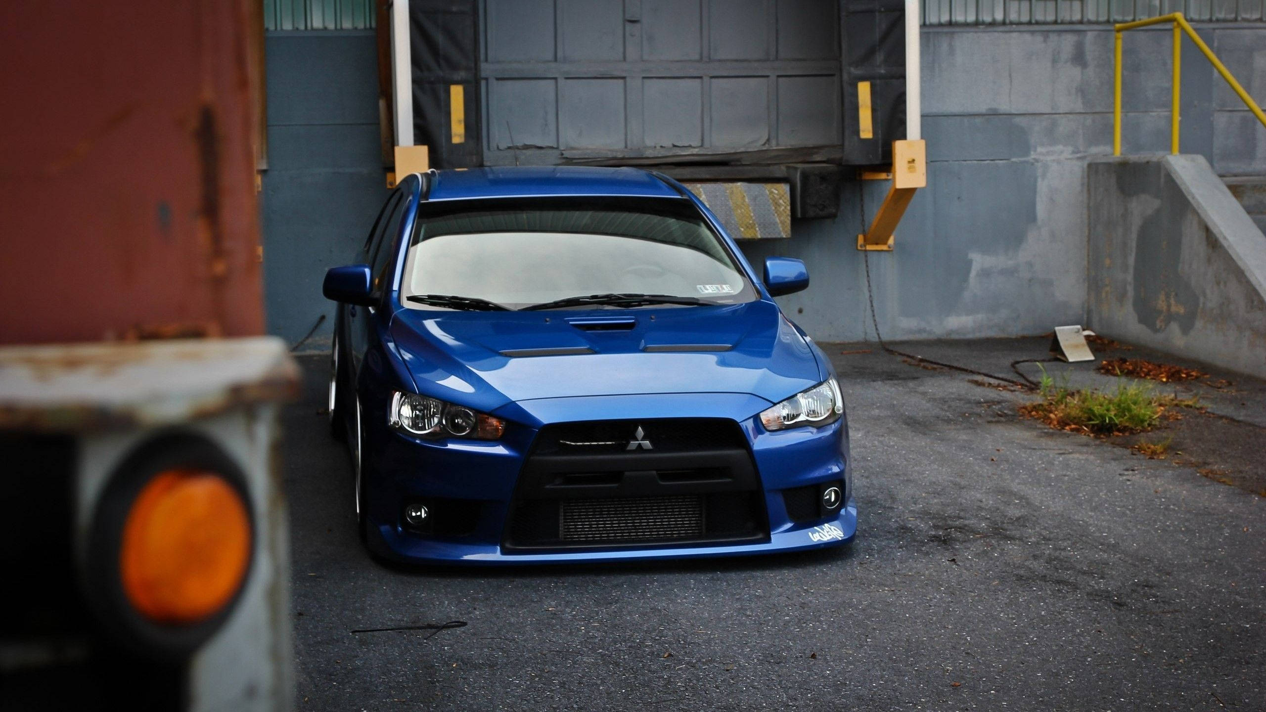 2010 Mitsubishi Lancer Evolution, vibrant blue, warehouse door, 2K Desktop Wallpaper