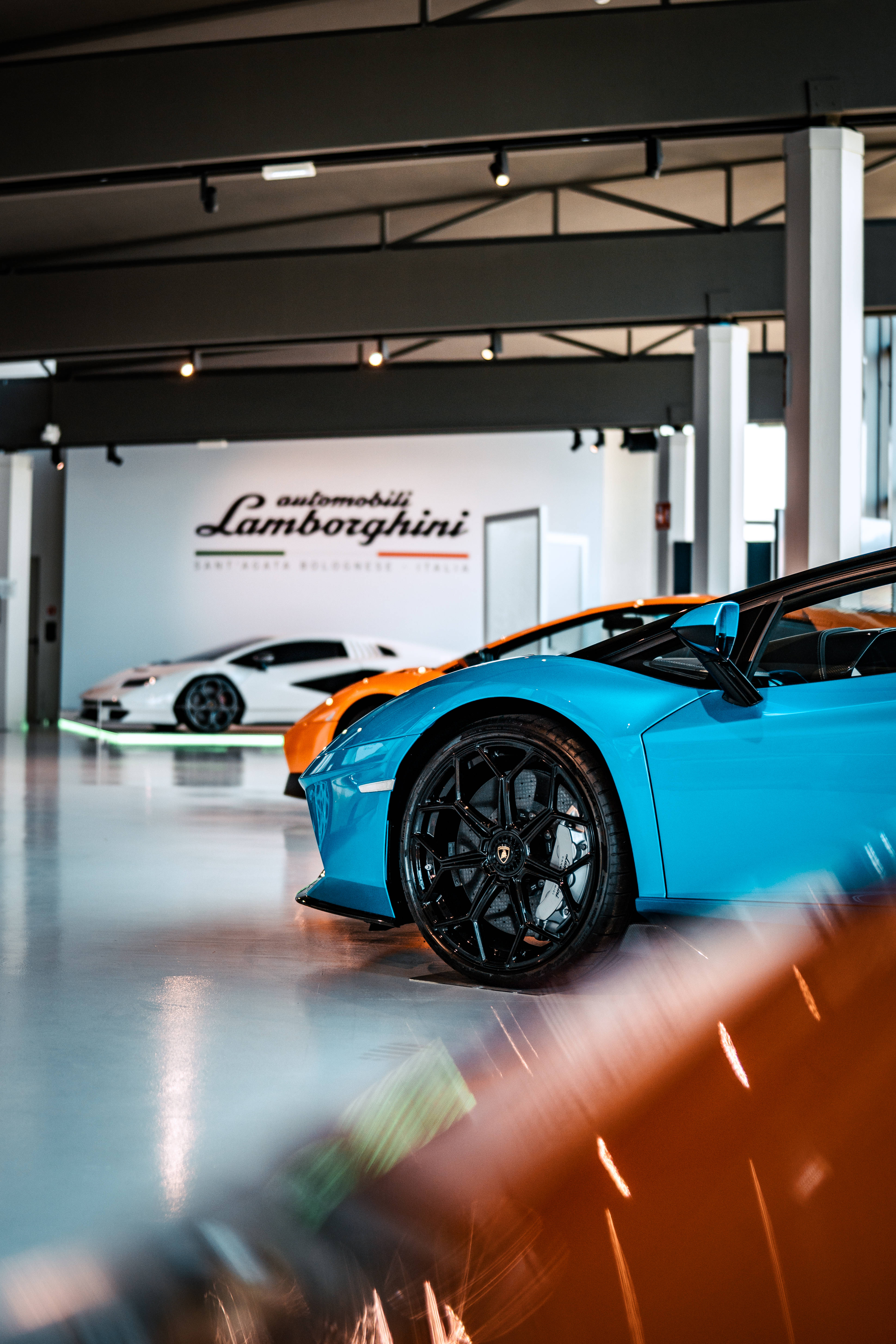 Lamborghini, vibrant blue, modern showroom, 5K Phone Wallpaper
