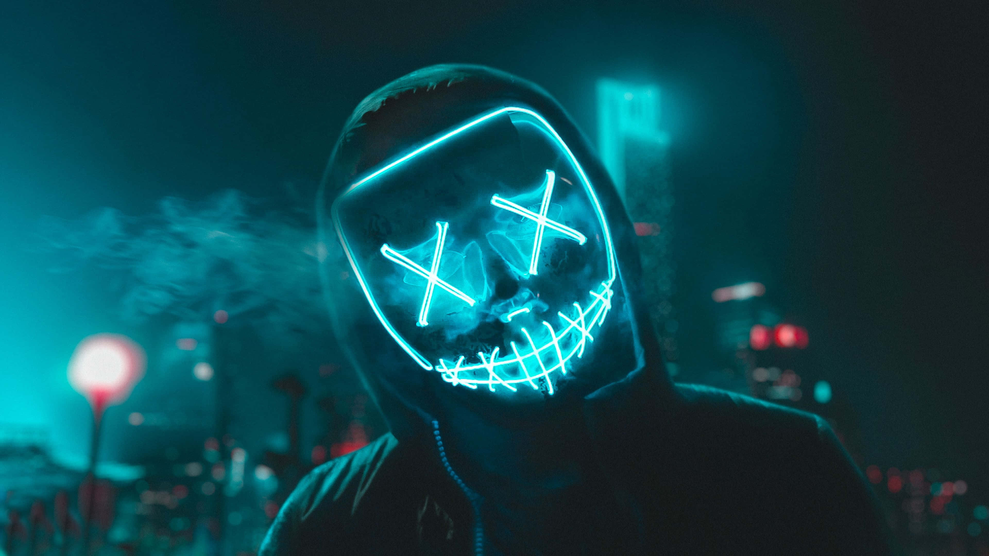glowing blue LED skull mask, neon-lit cityscape, night, 4K Desktop Wallpaper
