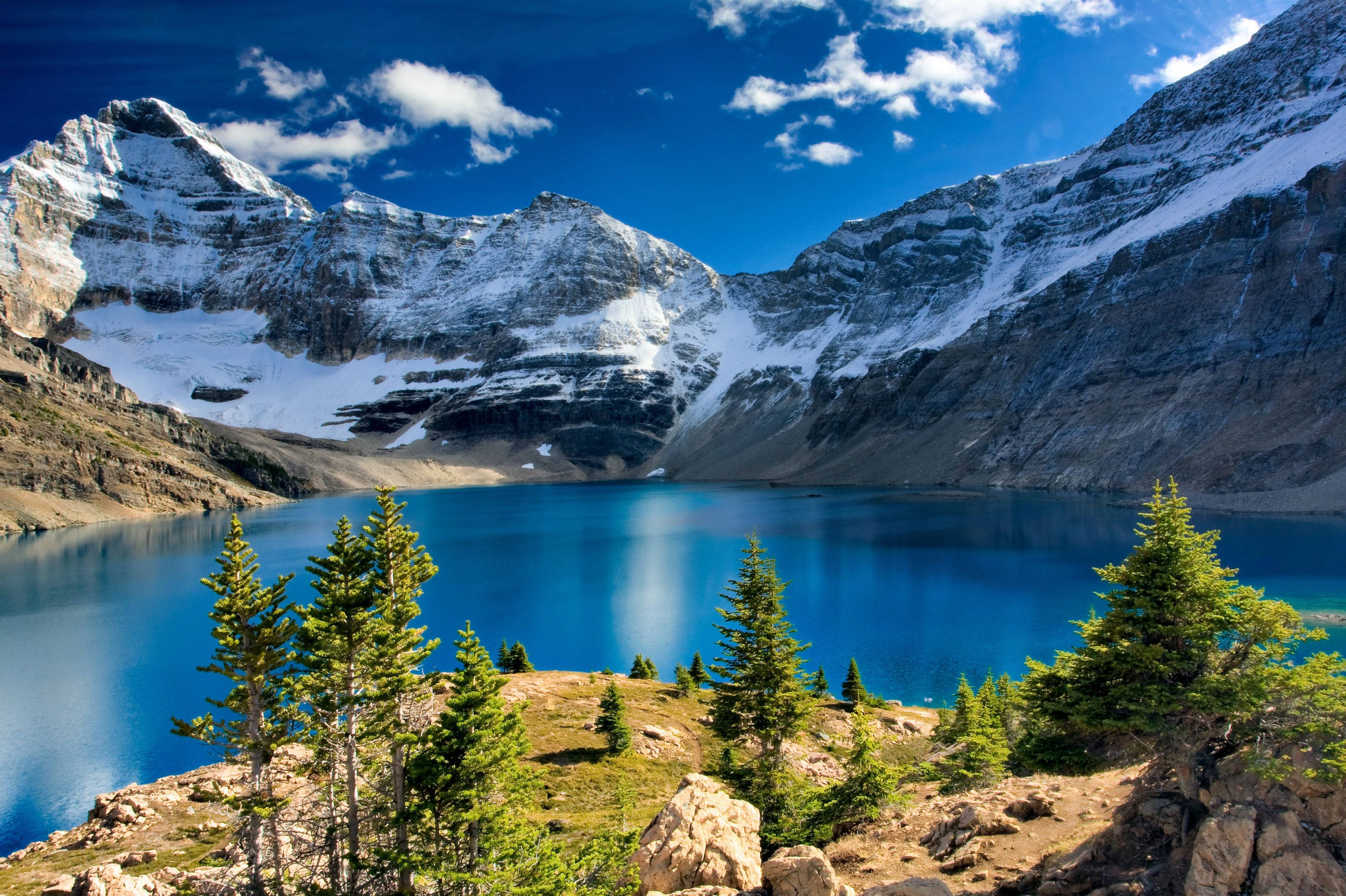 alpine lake, vibrant blue water, snow-capped mountains, 2K Desktop Wallpaper