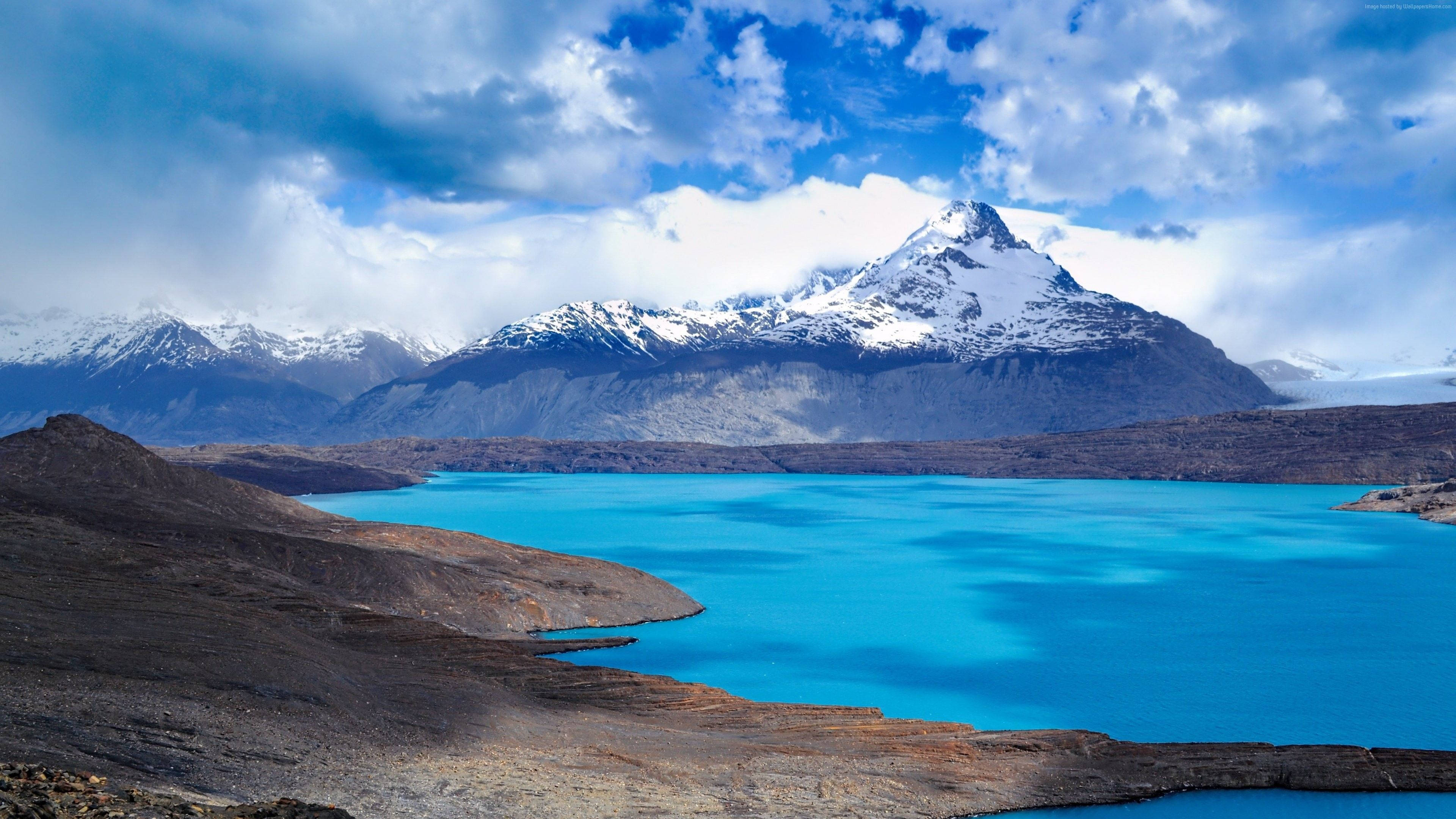alpine lake, vibrant turquoise waters, rugged brown hills, 4K Desktop Wallpaper