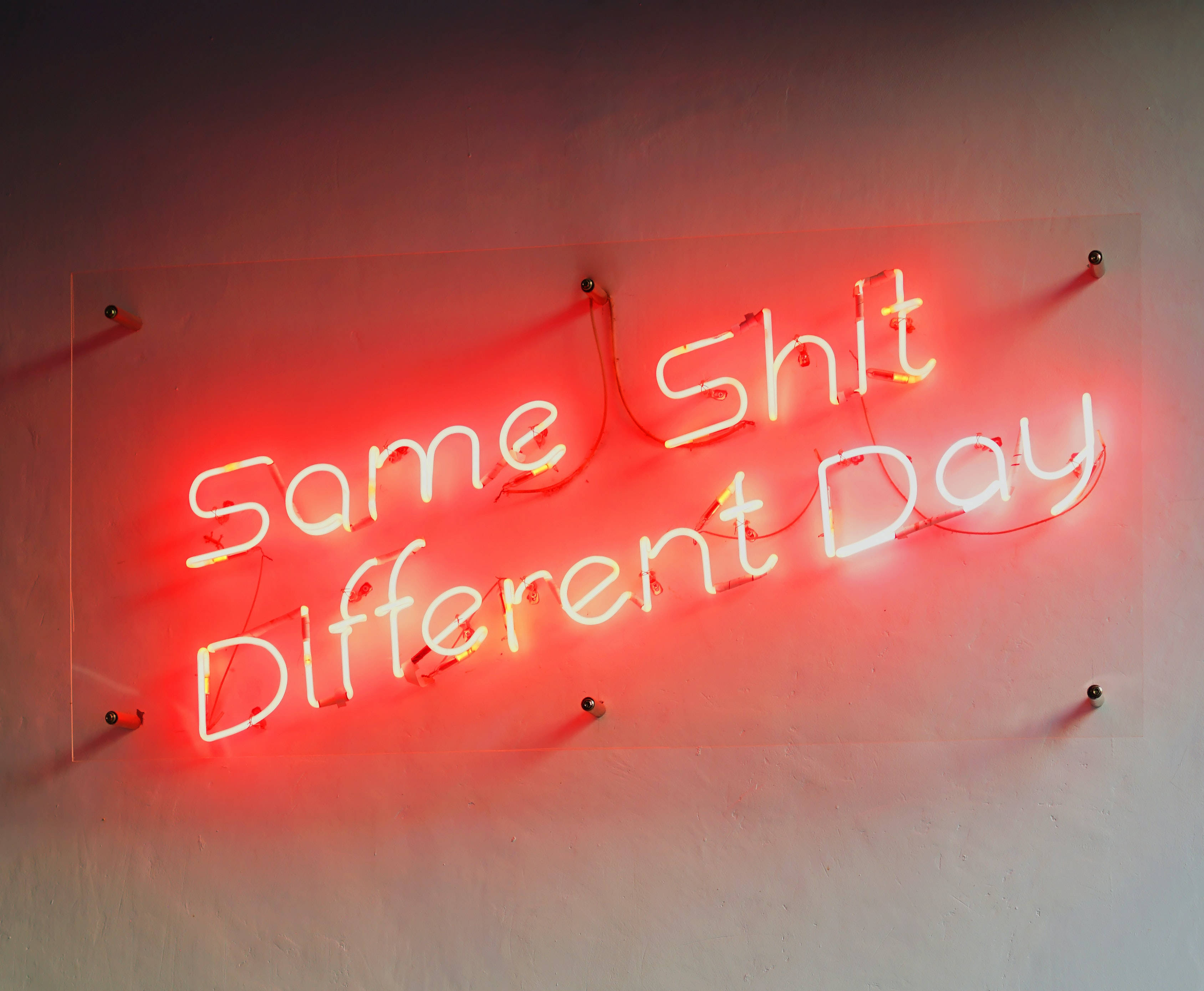 Same Shit Different Day, glowing red neon sign, plain wall, 2K Desktop Wallpaper