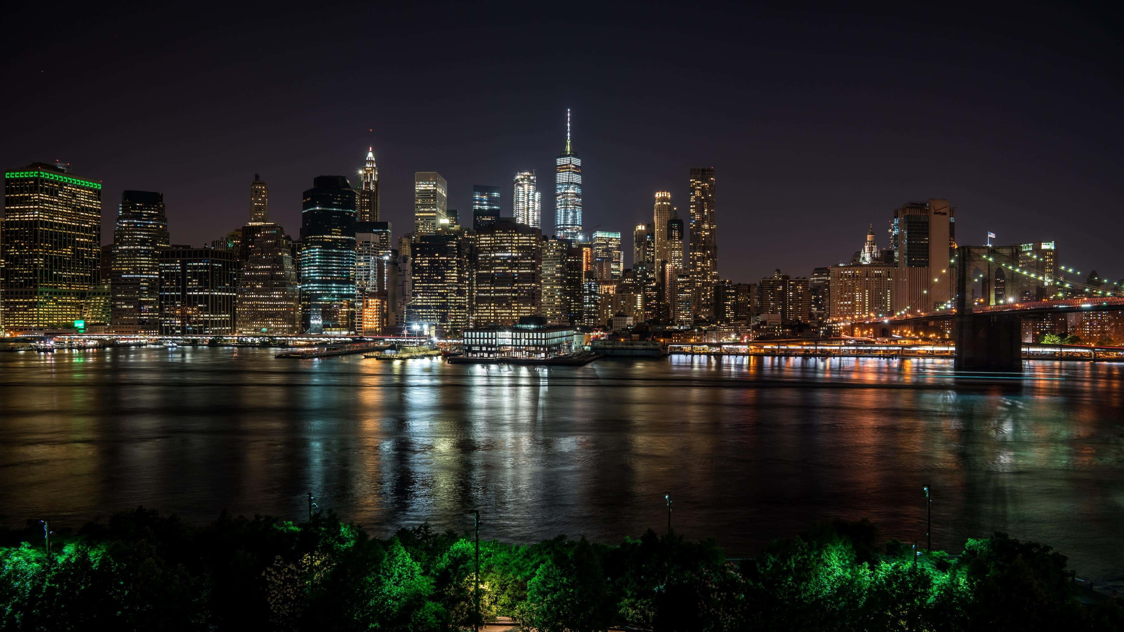 New York City, nighttime cityscape, glowing skyscrapers, 4K Desktop Wallpaper