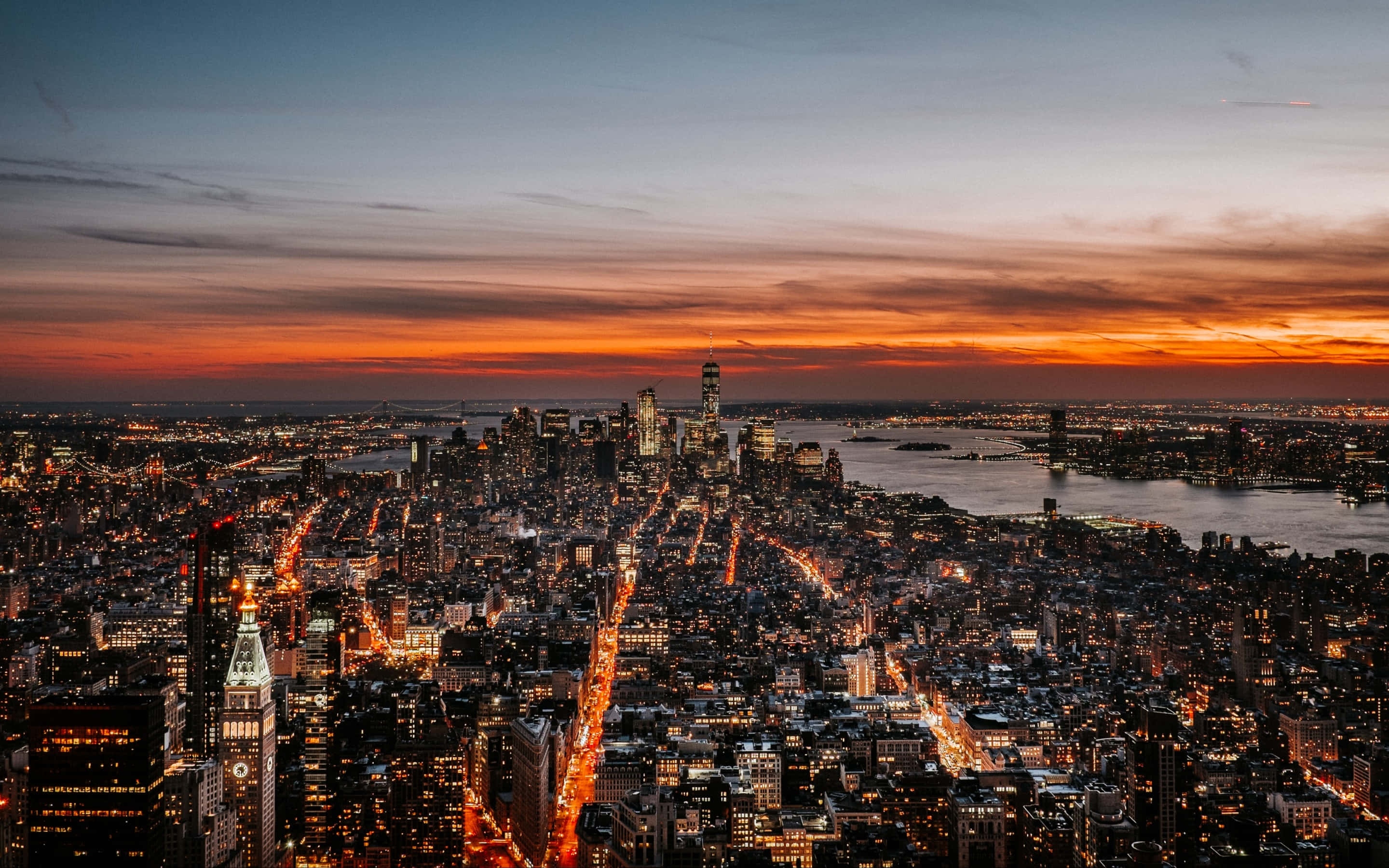 New York City skyline, dusk, fiery orange sunset, 2K Desktop Wallpaper