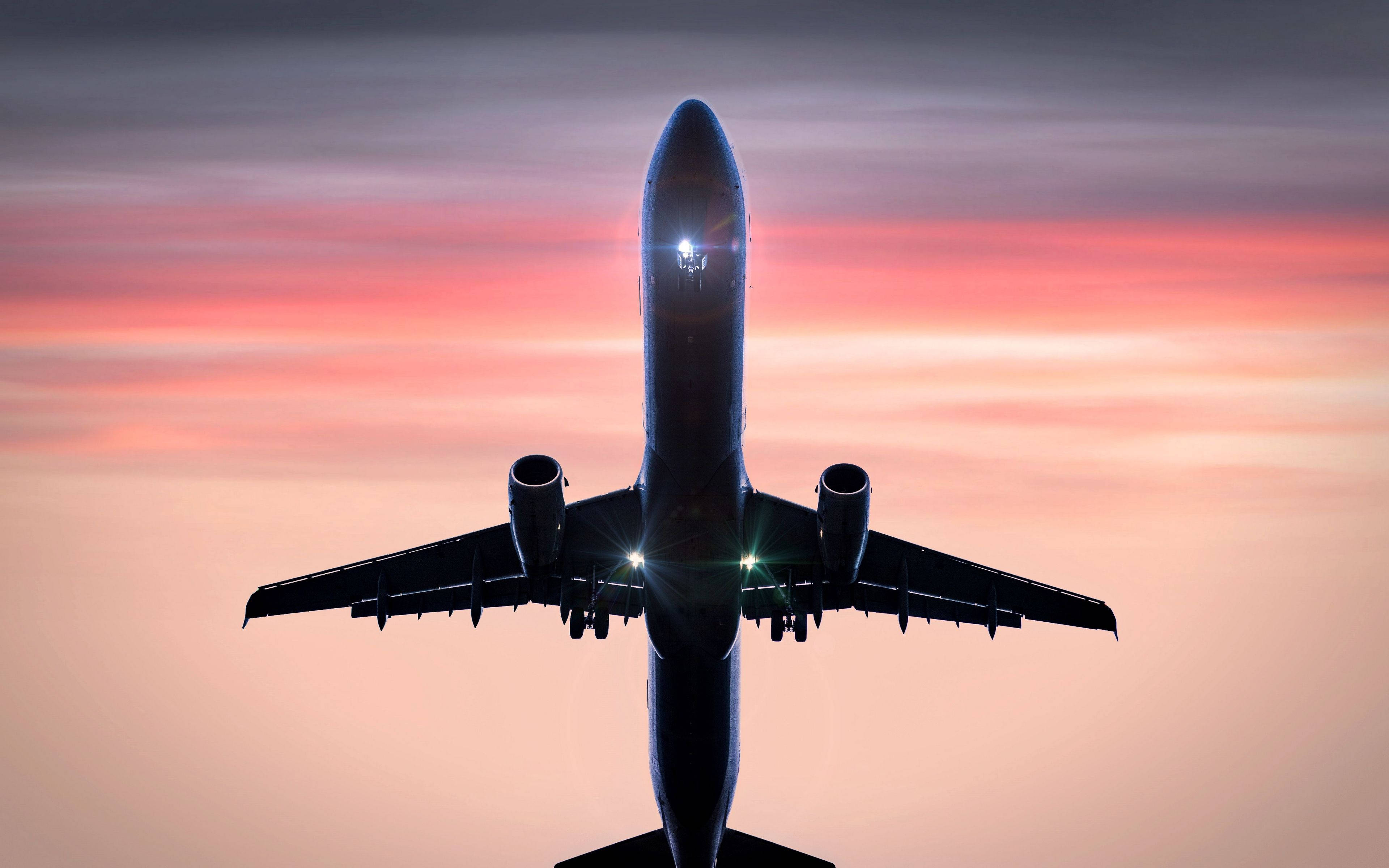 4K Plane, vibrant pink and orange sunset sky, glowing cockpit lights, 4K Desktop Wallpaper