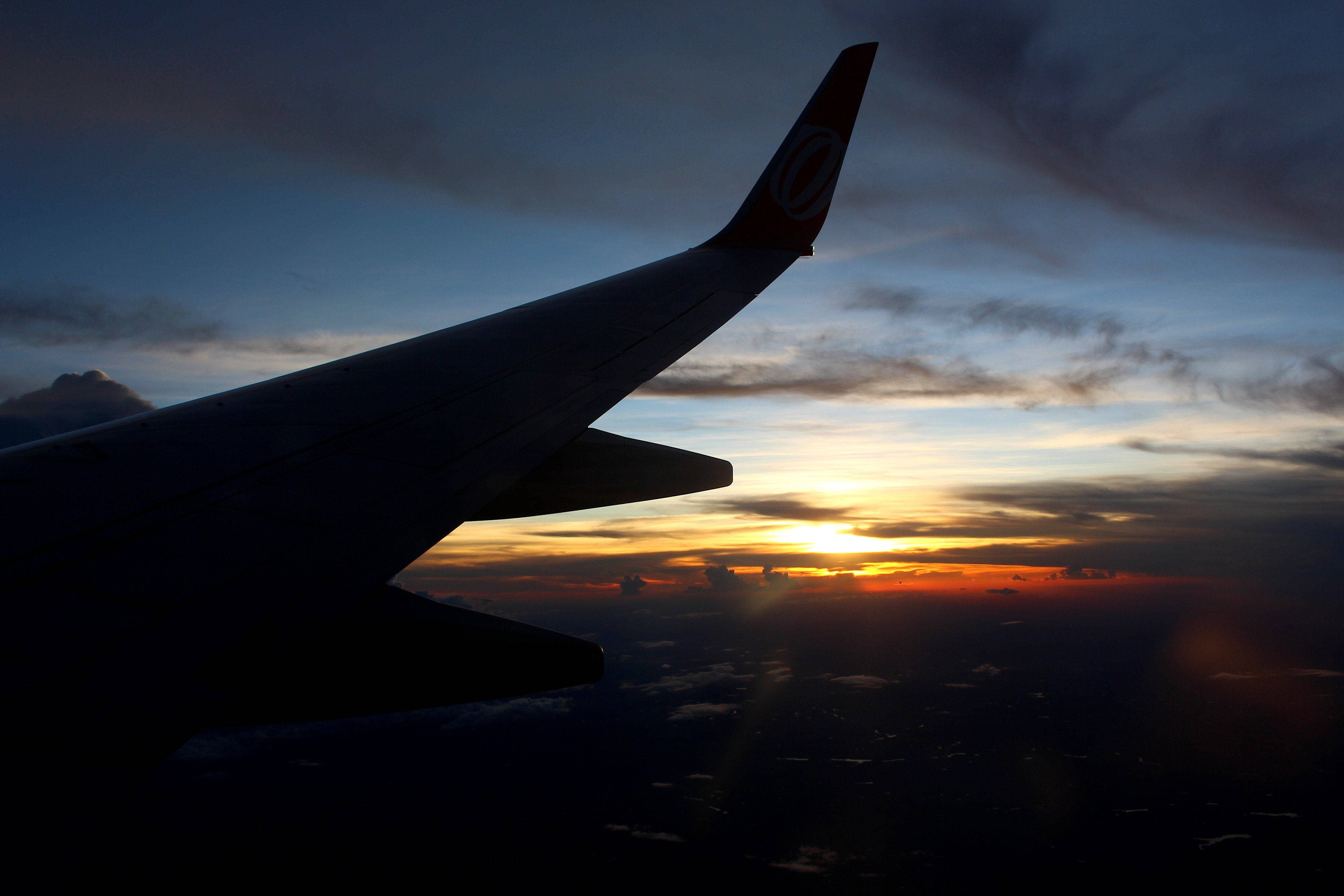 silhouette wing airplane, vibrant sunset sky, orange and blue hues, 4K Desktop Wallpaper