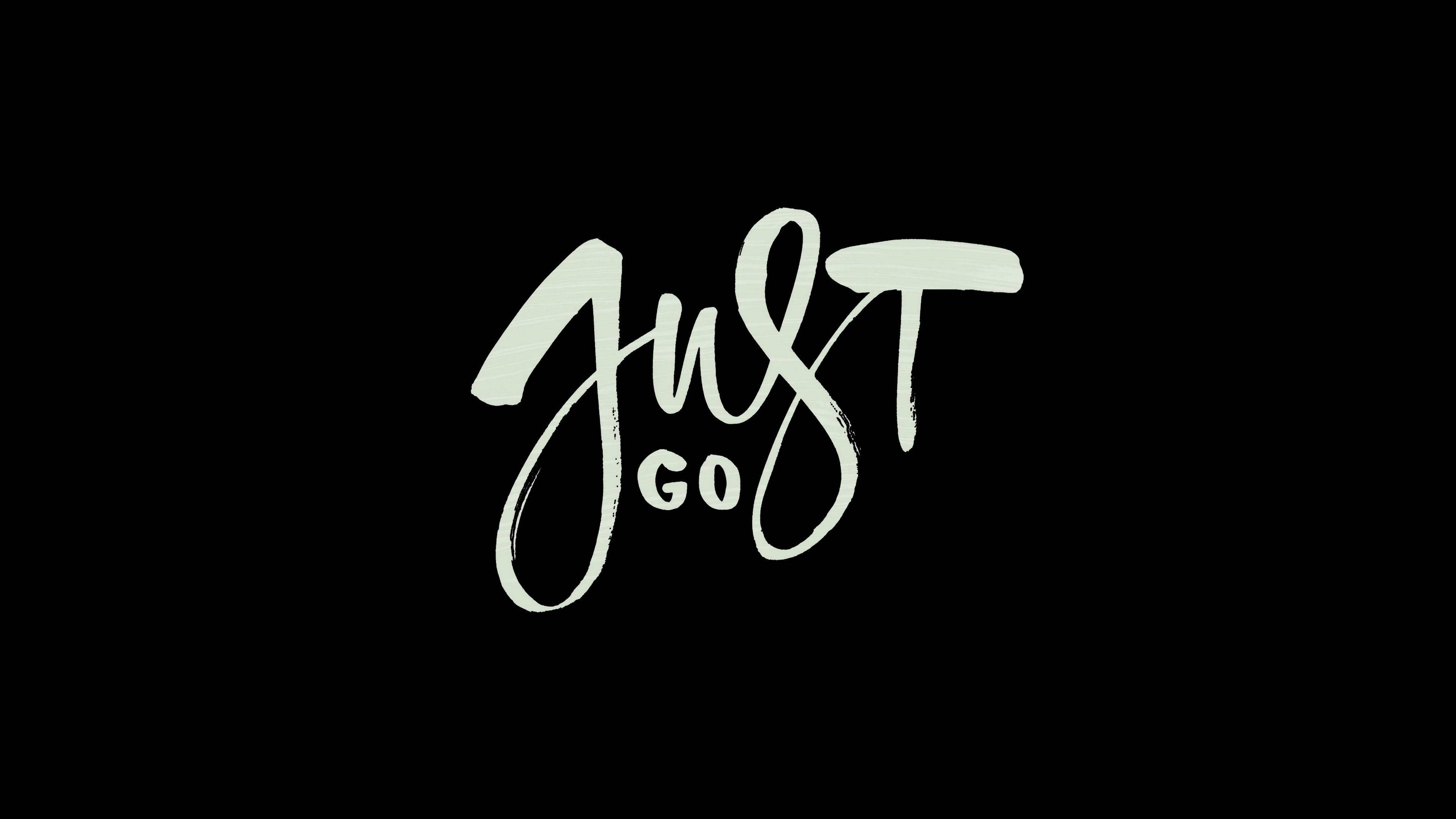 JUST GO, white brush-stroke lettering, solid black background, 4K Desktop Wallpaper
