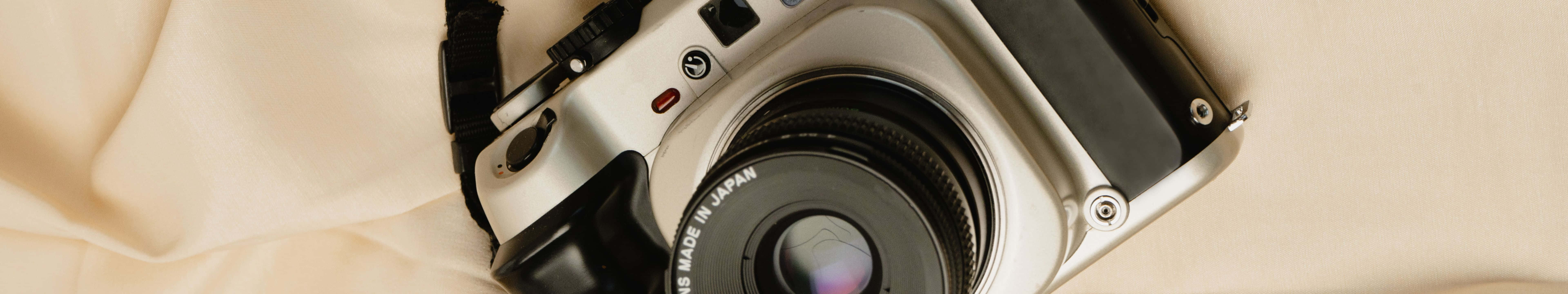 7680 x 1440, vintage silver and black camera, soft beige fabric, 8K Desktop Wallpaper