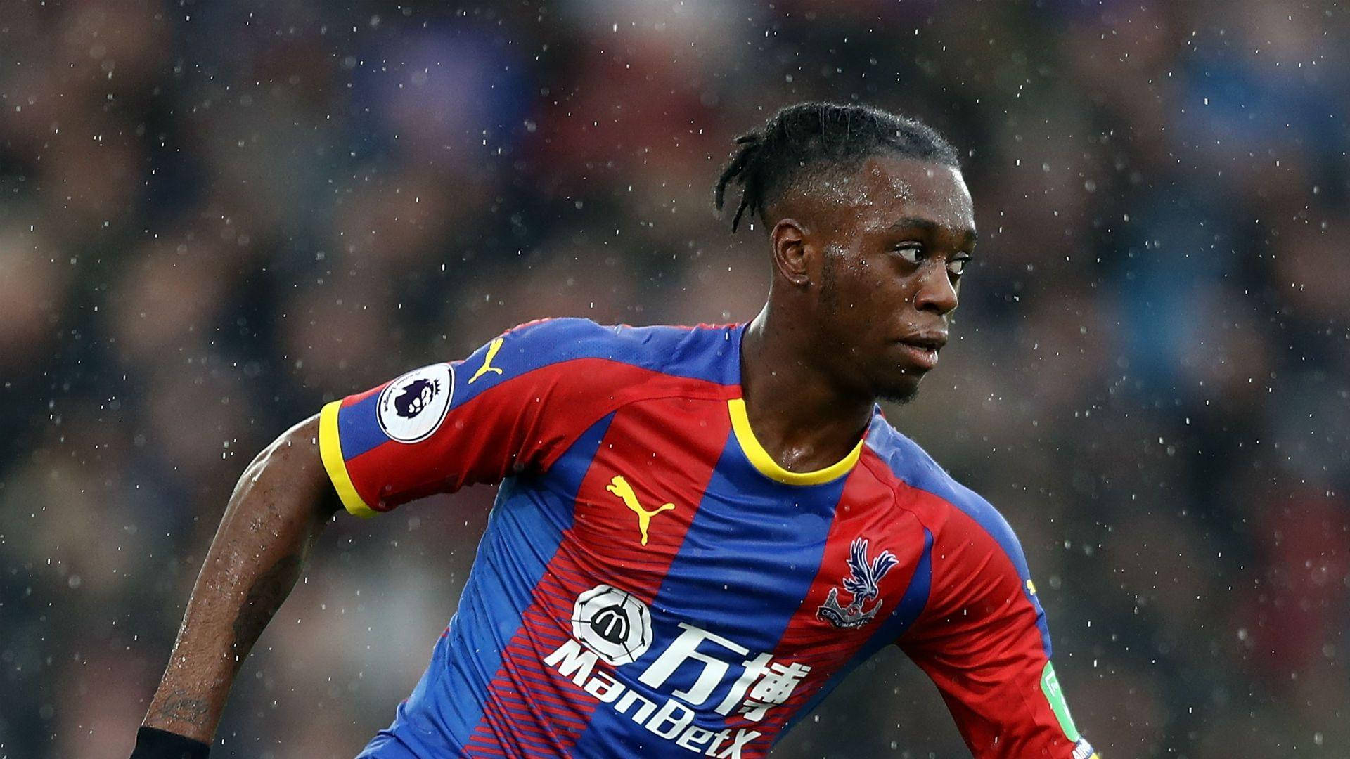 Aaron Wan-Bissaka, red and blue jersey, sprints through rain, Full HD Desktop Wallpaper