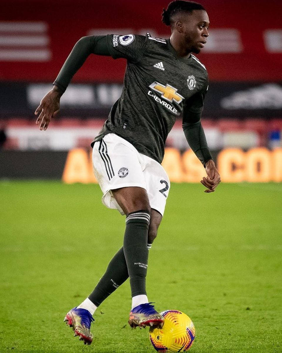 Aaron Wan-Bissaka, dark jersey, vibrant yellow ball, SD Phone Wallpaper
