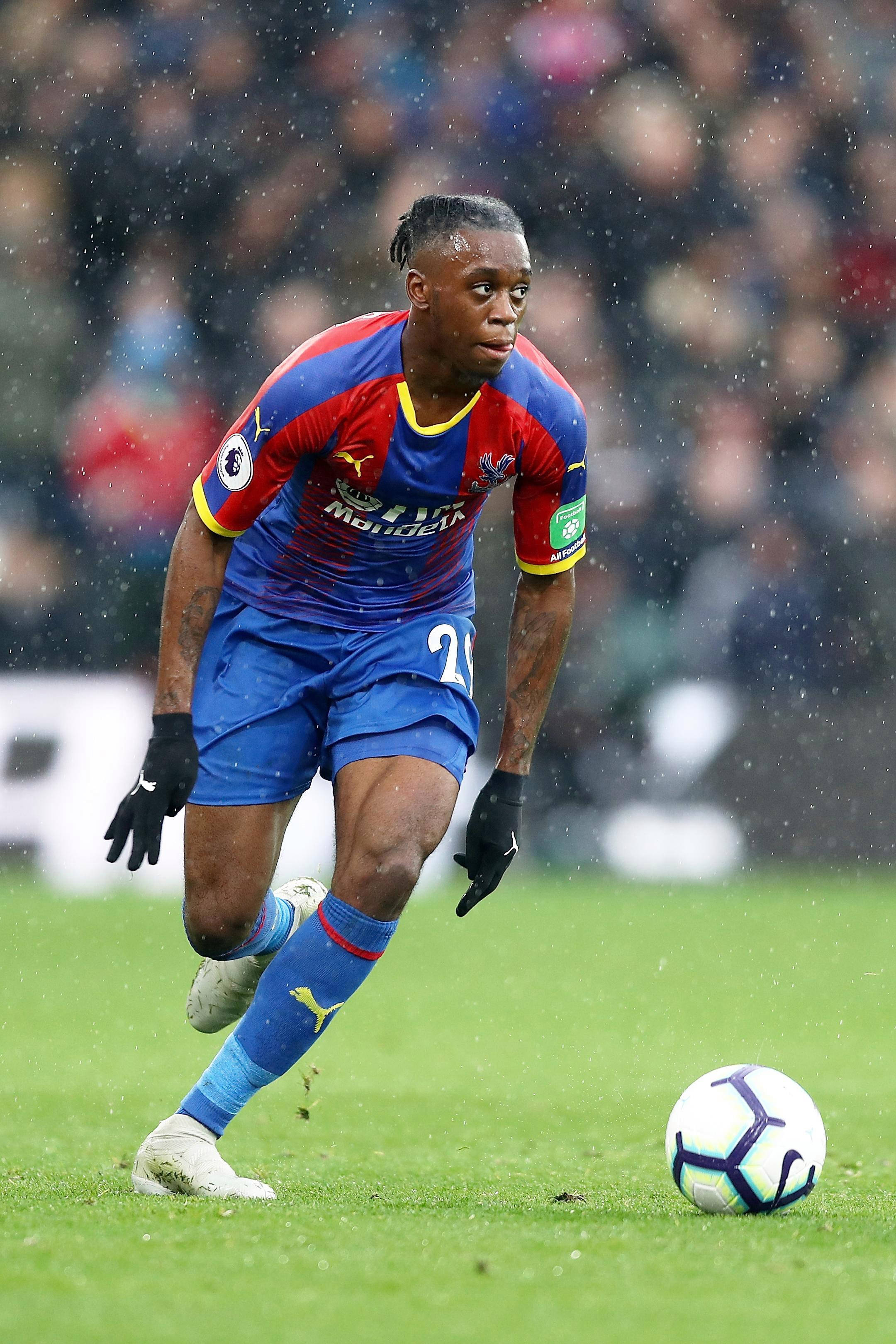 Aaron Wan-Bissaka, blue and red kit, wet grass field, 2K Phone Wallpaper