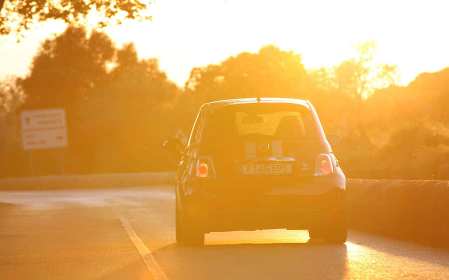Abarth 695 Tributo Ferrari, sun-drenched road, golden light, SD Desktop Wallpaper