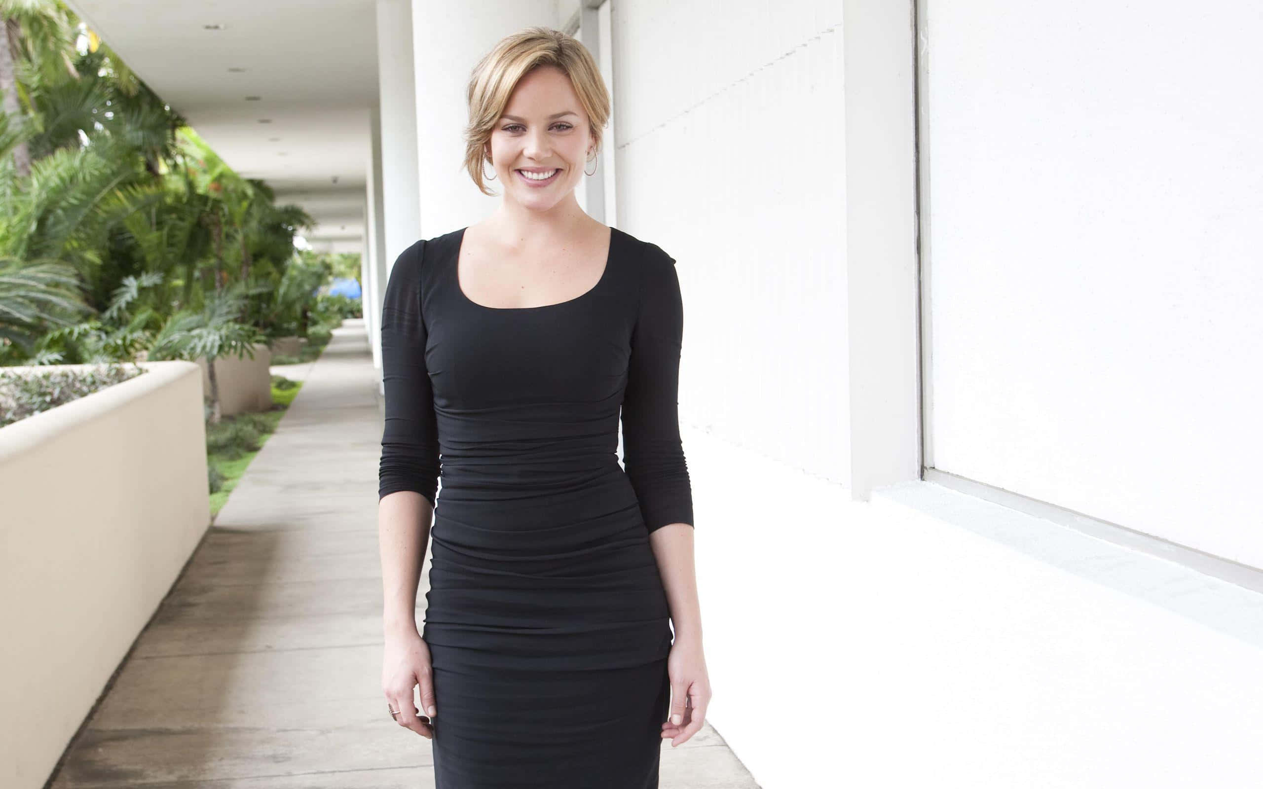 Abbie Cornish, black dress, bright modern corridor, 2K Desktop Wallpaper