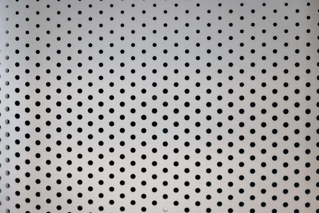 white perforated metal sheet, evenly spaced black circular holes, rhythmic industrial texture, SD Desktop Wallpaper