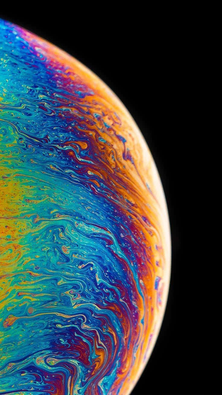 vibrant soap bubble planet, iridescent blues greens yellows and oranges, stark black void, HD Phone Wallpaper