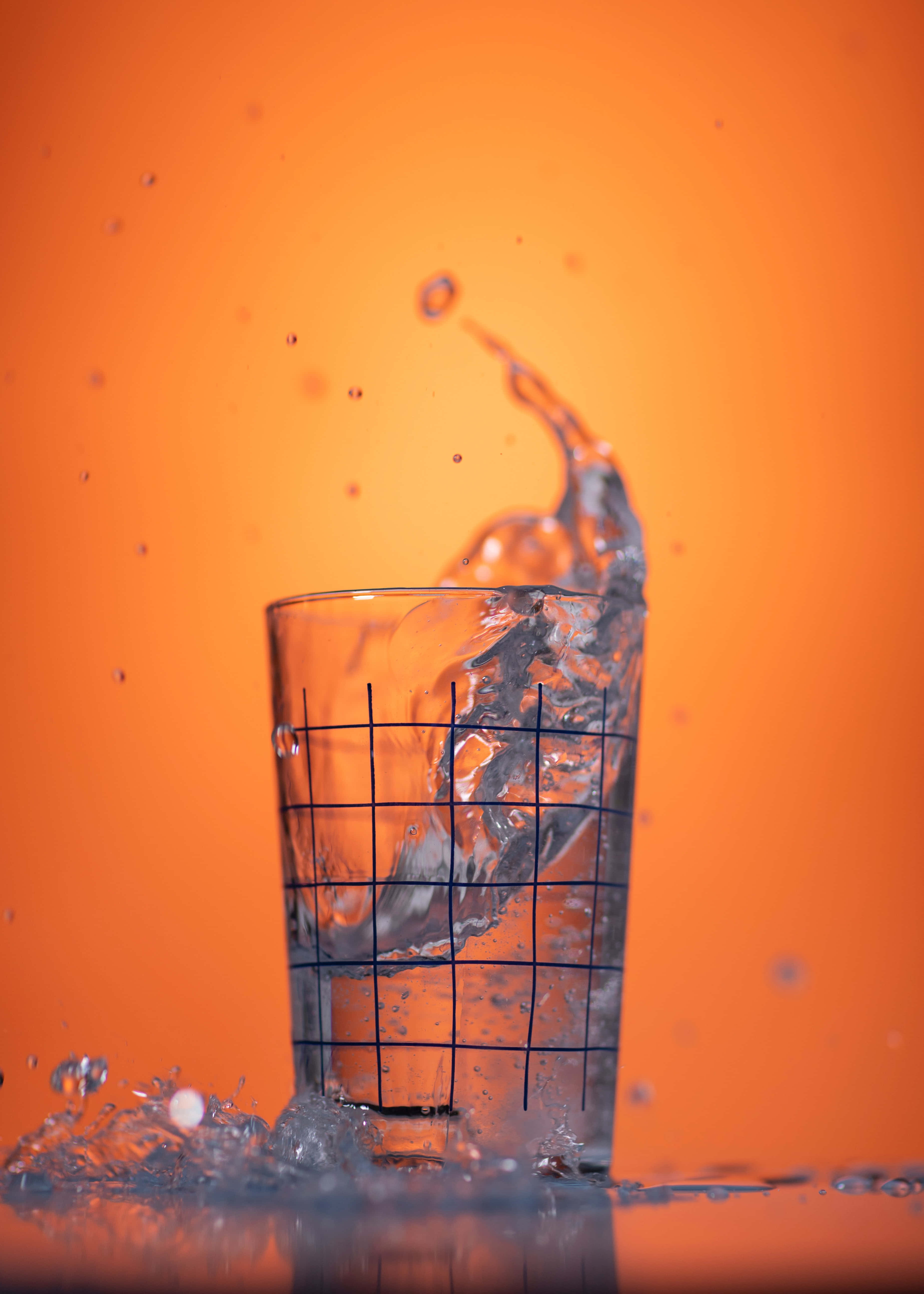 water bliss, glass, vibrant orange background, 5K Phone Wallpaper