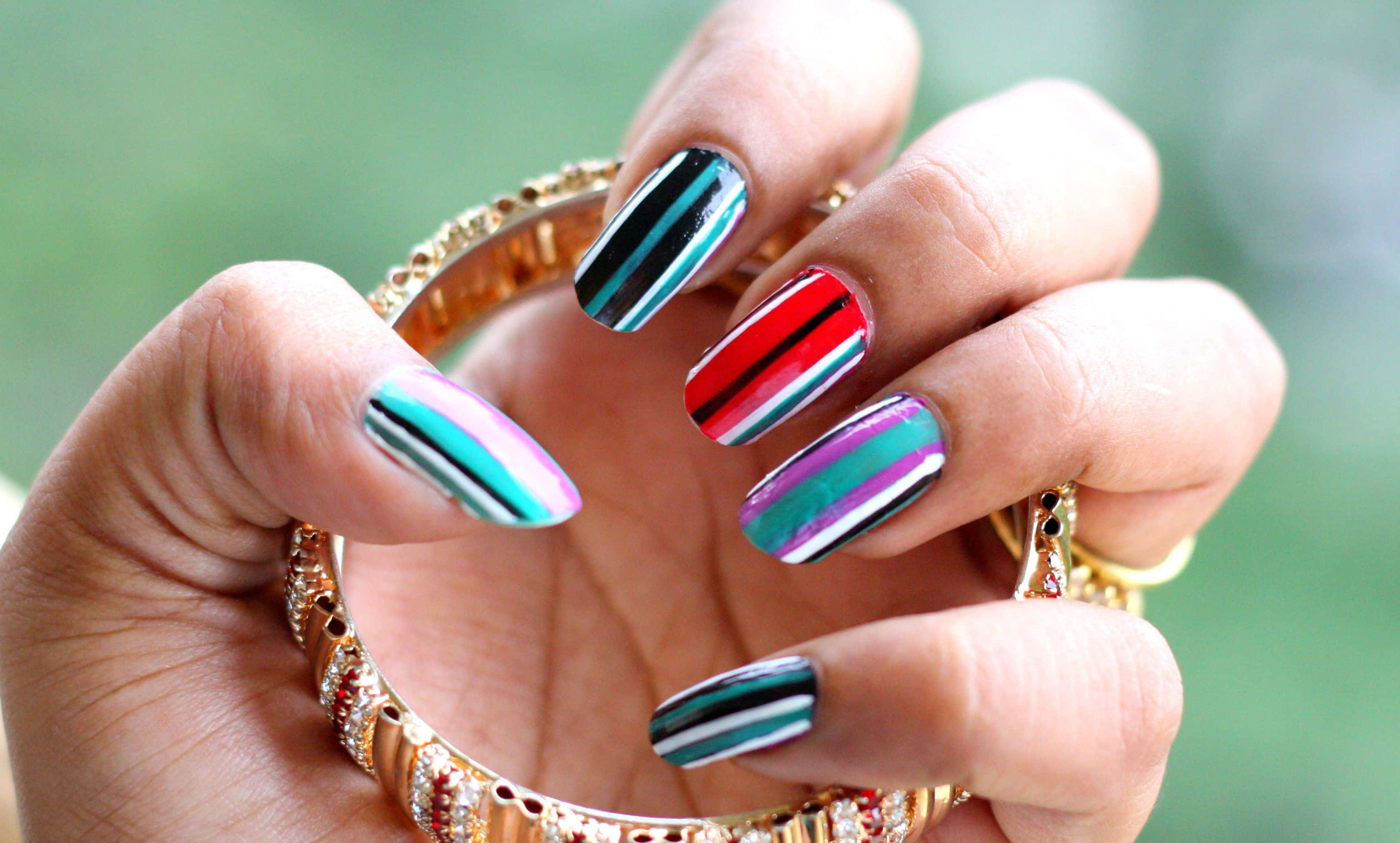 acrylic nails, vibrant multicolored striped nails, ornate gold bangles, 2K Desktop Wallpaper
