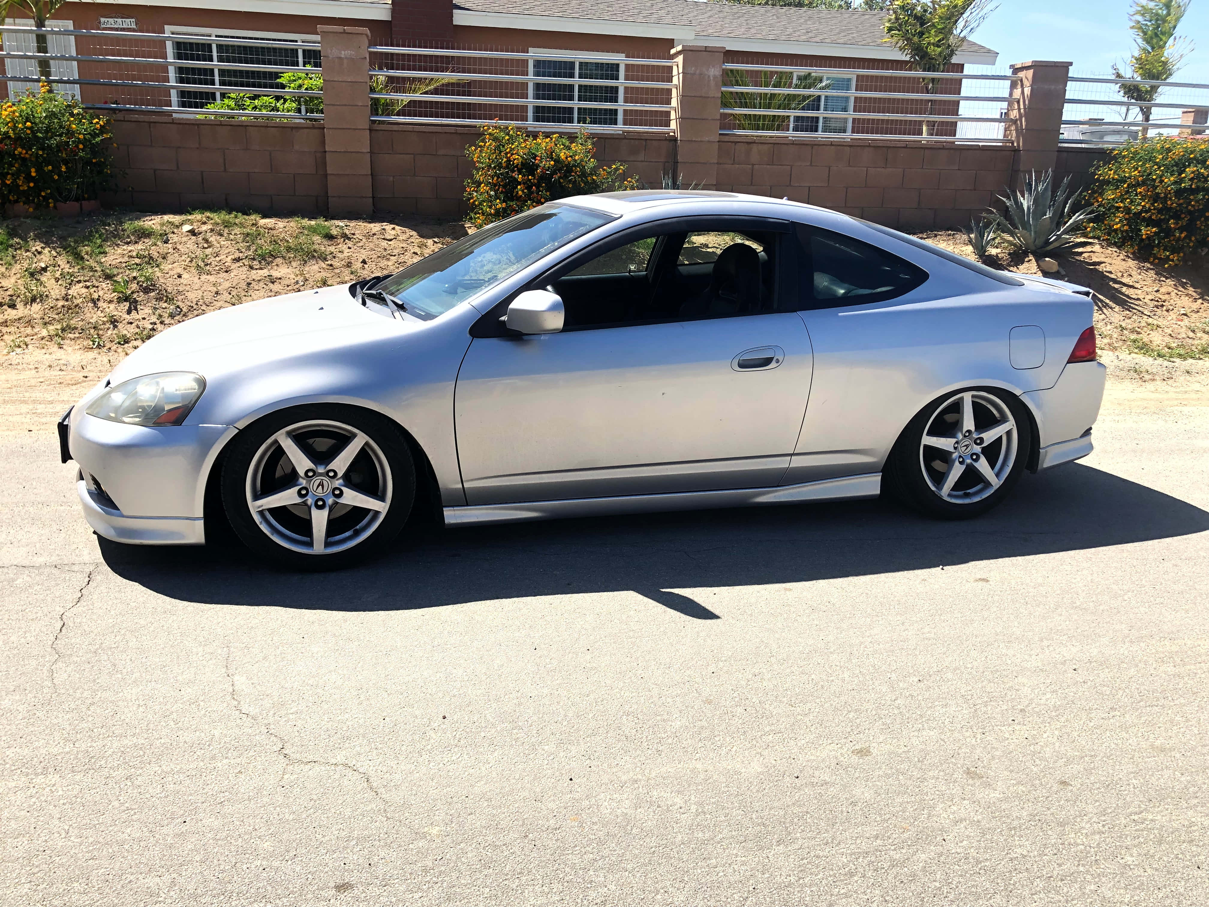 Acura RSX, sleek silver sports coupe, scenic mountain road, 4K Desktop Wallpaper