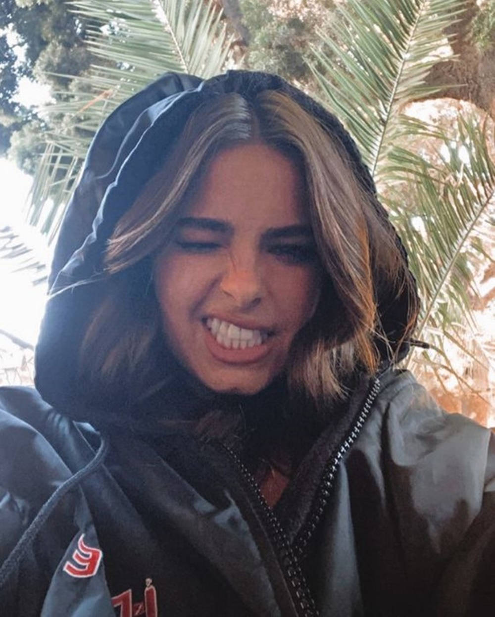 Addison Rae, black hooded jacket, palm trees, SD Phone Wallpaper