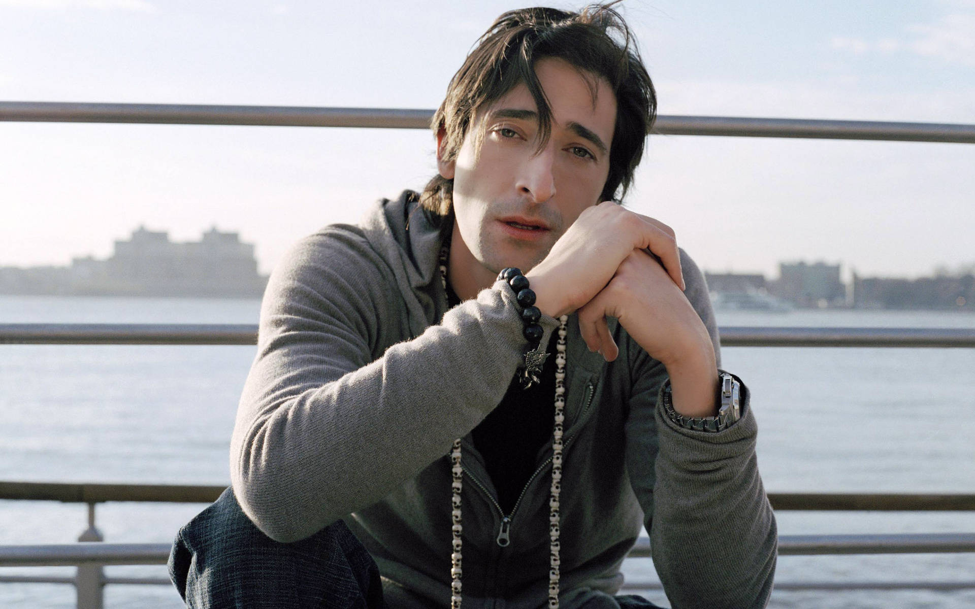 Adrien Brody, grey hoodie, waterfront railing, Full HD Desktop Wallpaper