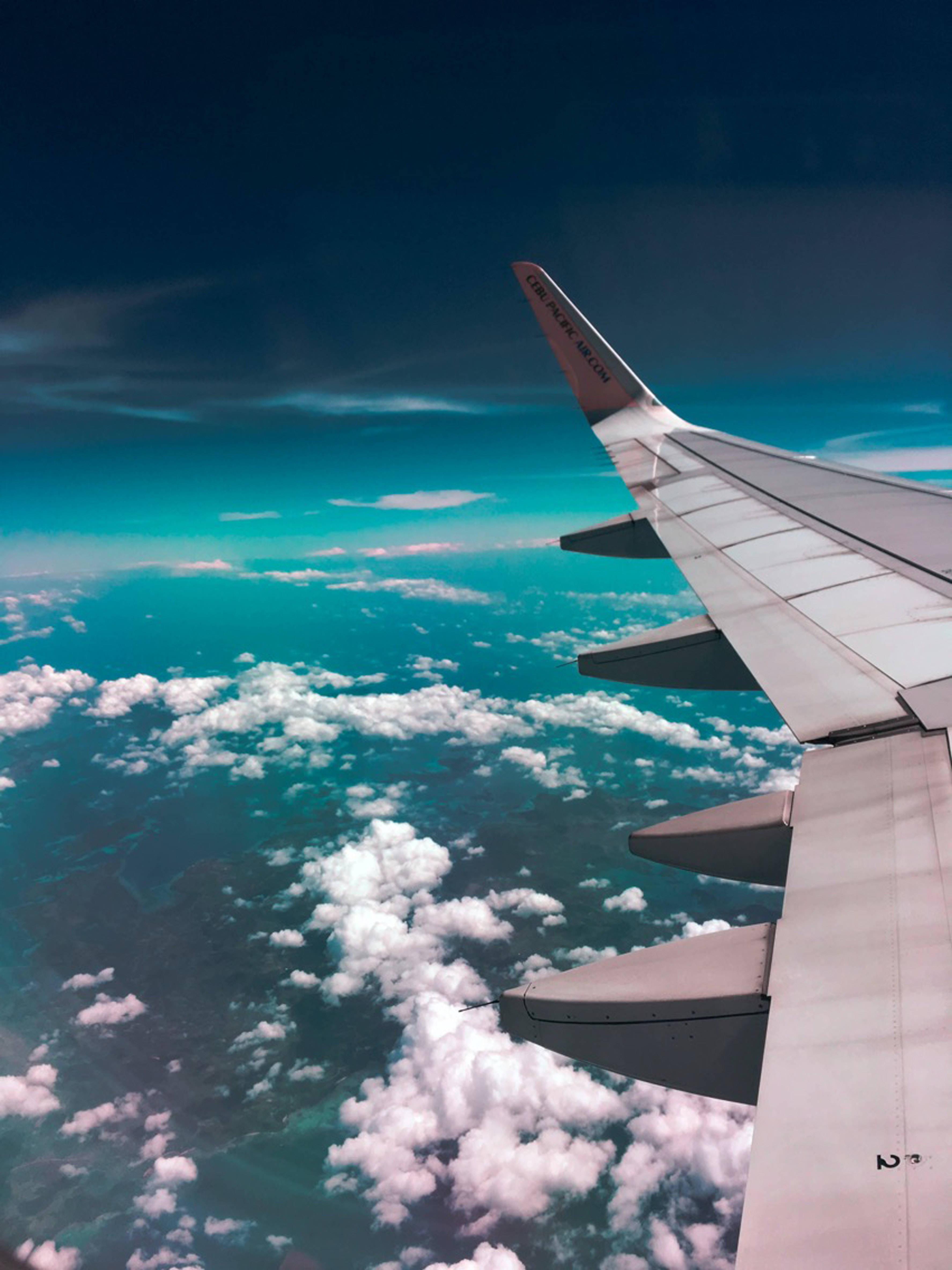 Aeroplane, turquoise ocean, fluffy white clouds, 4K Phone Wallpaper
