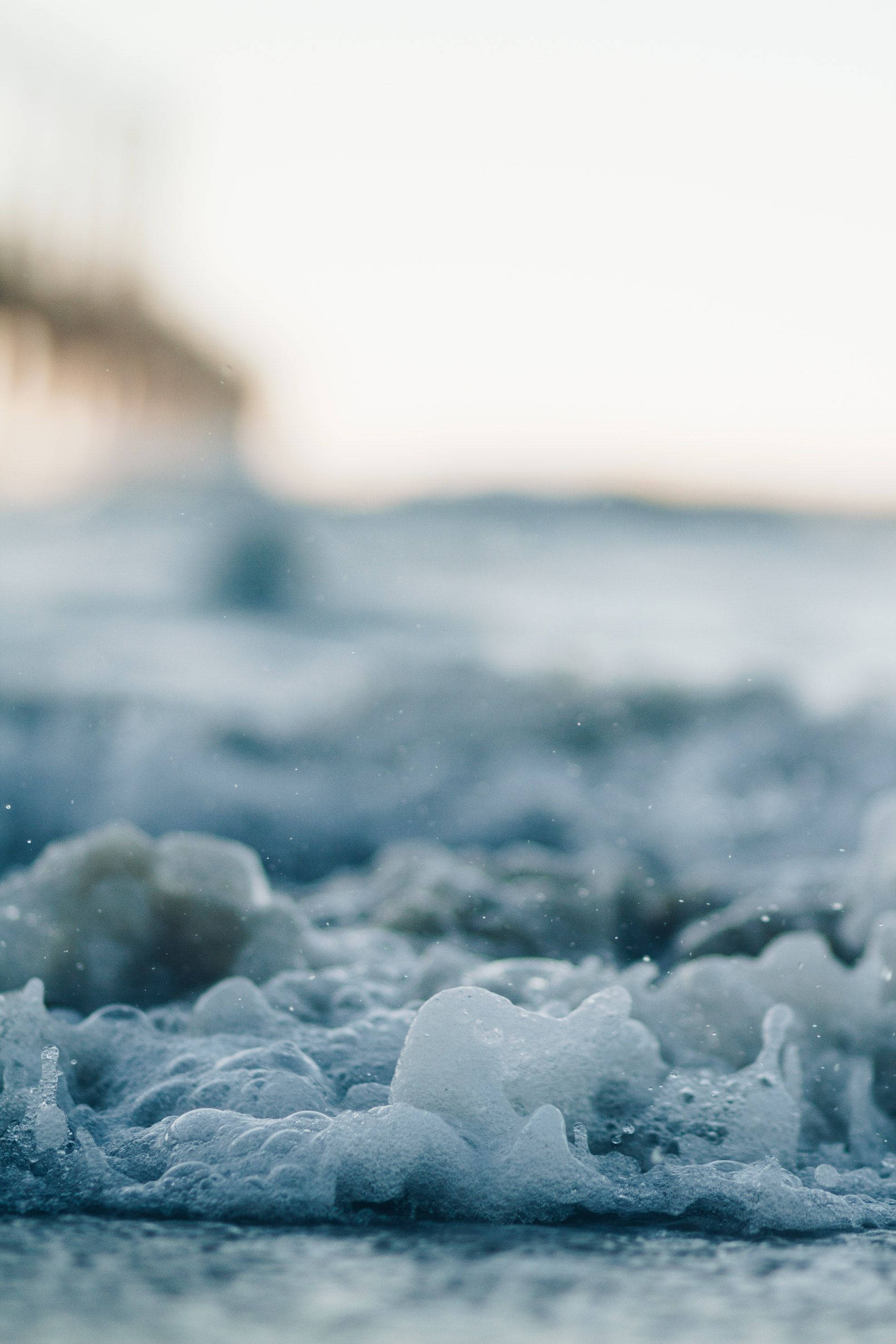 Aesthetic Beach, frothy ocean waves, soft blue and white tones, 2K Phone Wallpaper