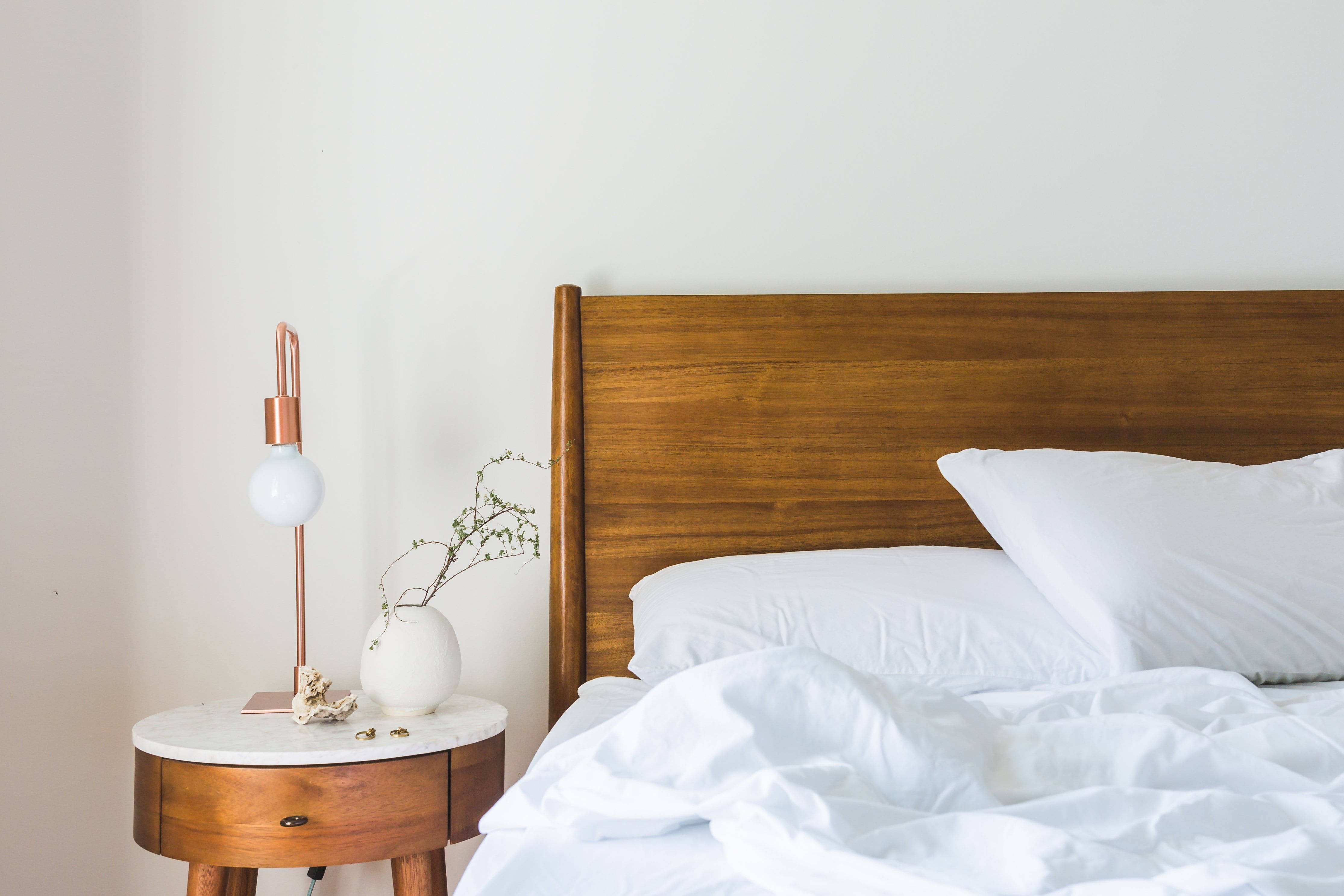 white aesthetic home bedroom, wooden headboard, rumpled white sheets, 4K Desktop Wallpaper