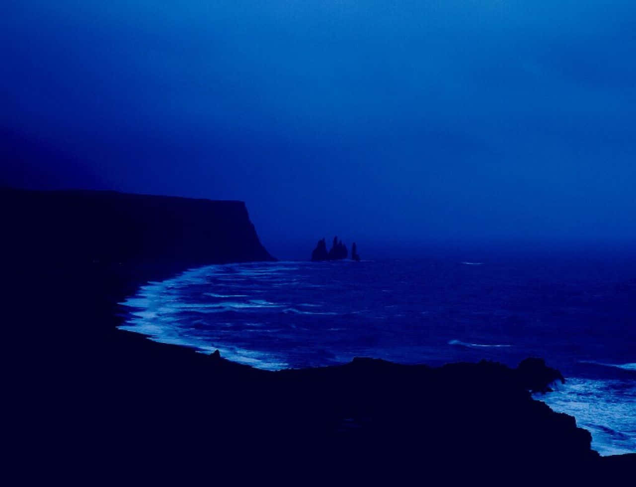 midnight coastal scene, dark cliffs, glowing blue waves, HD Desktop Wallpaper