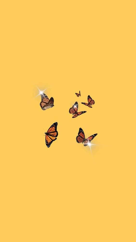 monarch butterflies, glowing star effects, solid warm yellow background, SD Phone Wallpaper