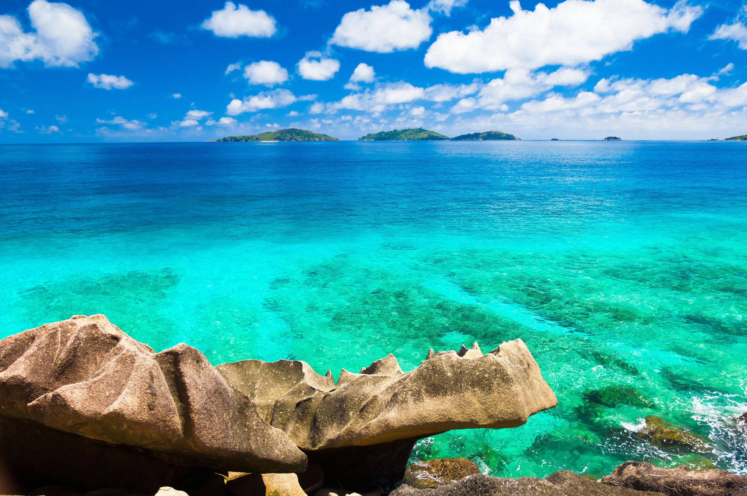 Ocean Coast Chromebook, turquoise waters, rugged brown rocks, 2K Desktop Wallpaper