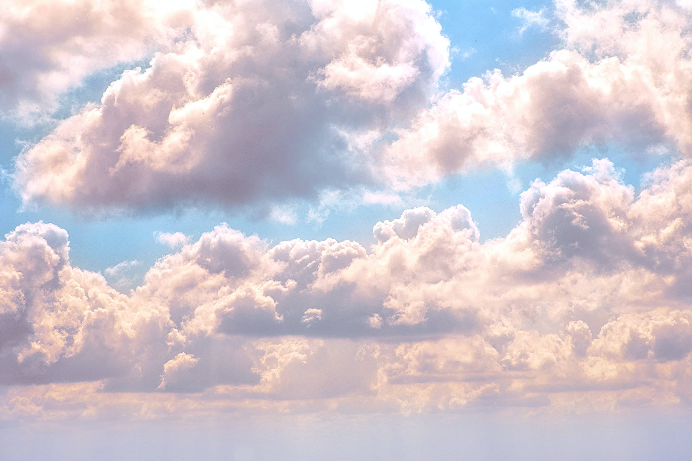 bright blue cloudy sky, fluffy cotton clouds, warm golden sunlight, Full HD Desktop Wallpaper