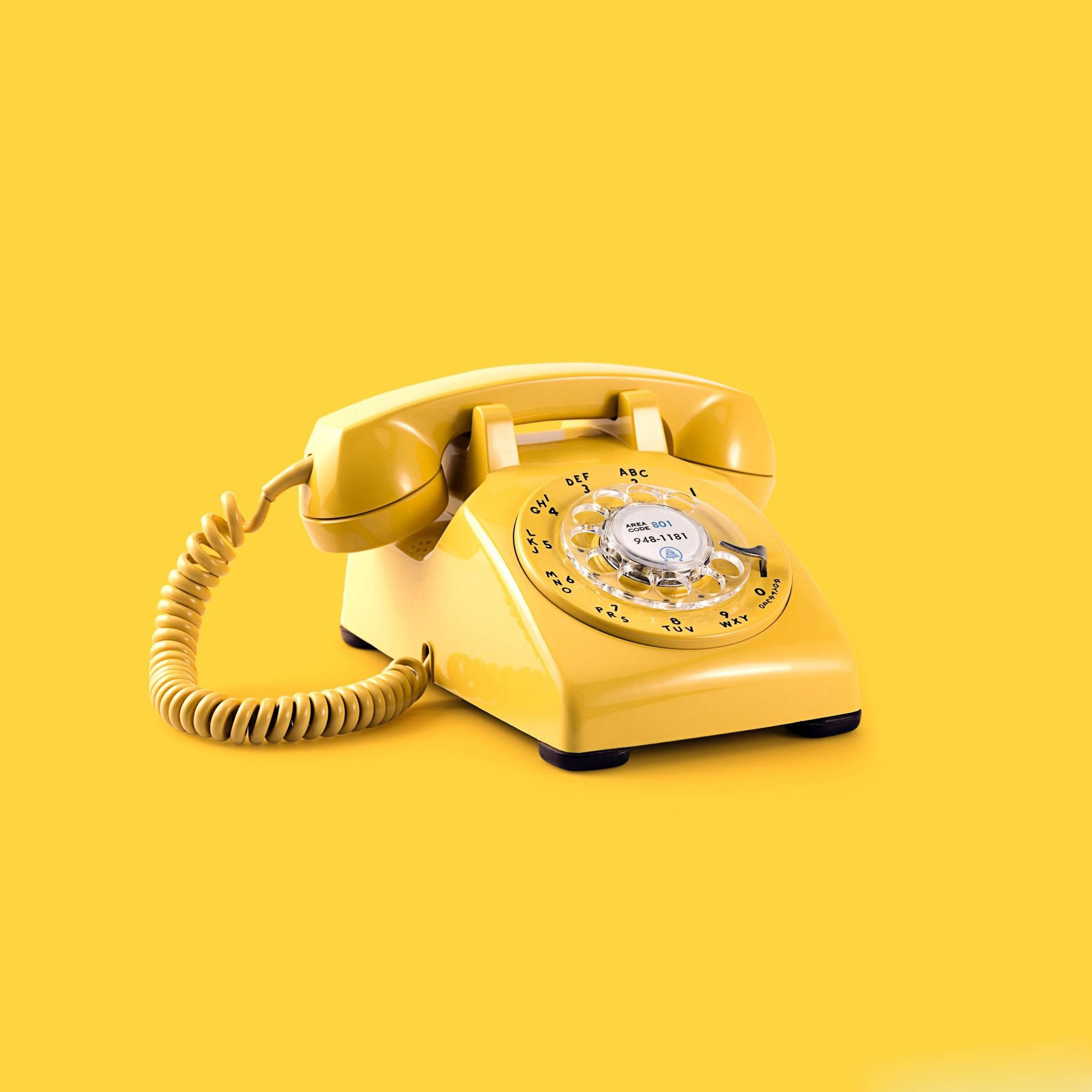 vintage yellow rotary telephone, solid yellow background, soft shadows, Full HD Desktop Wallpaper