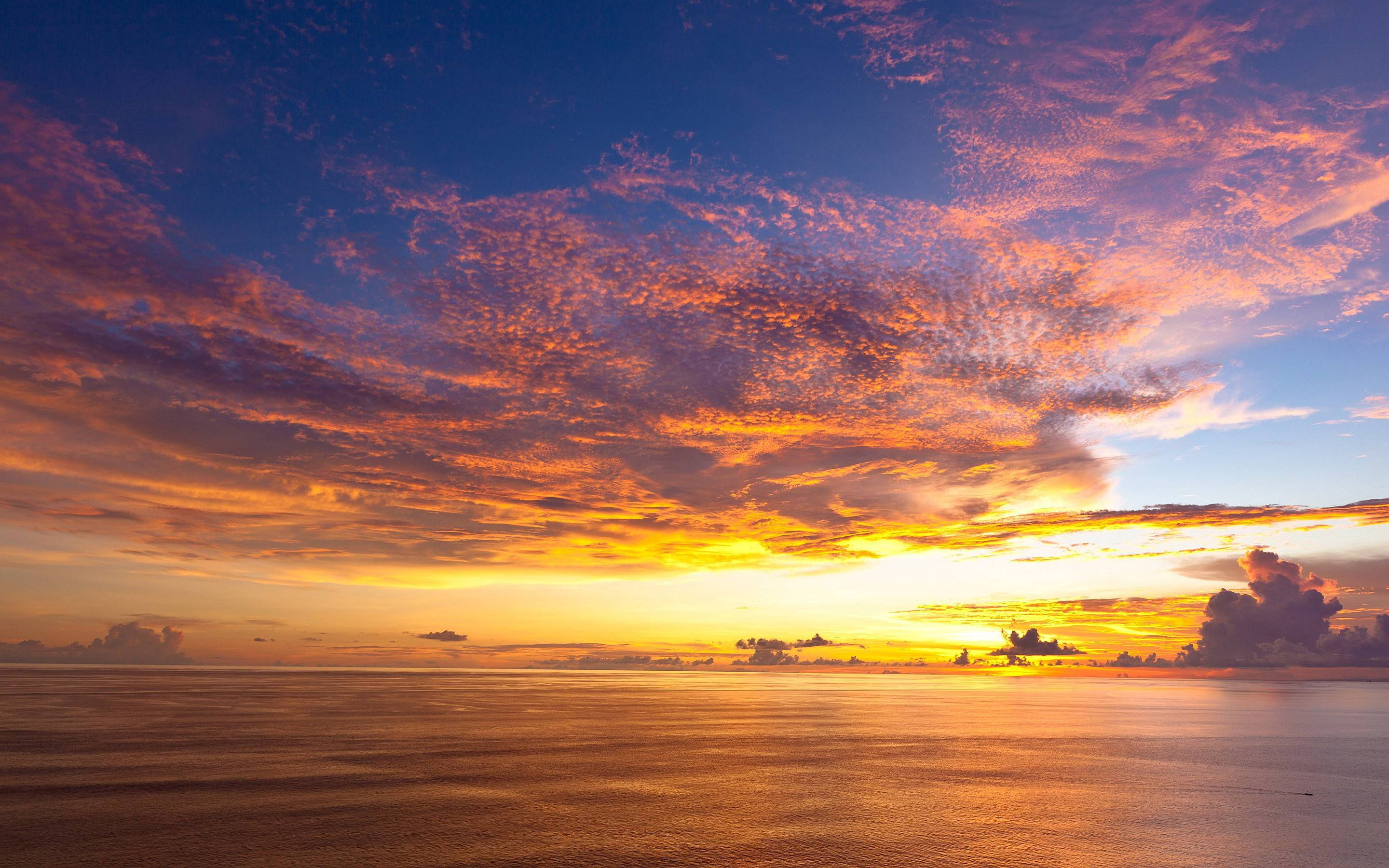 wide sky ocean sunset, calm ocean waters, fiery orange and purple clouds, 2K Desktop Wallpaper